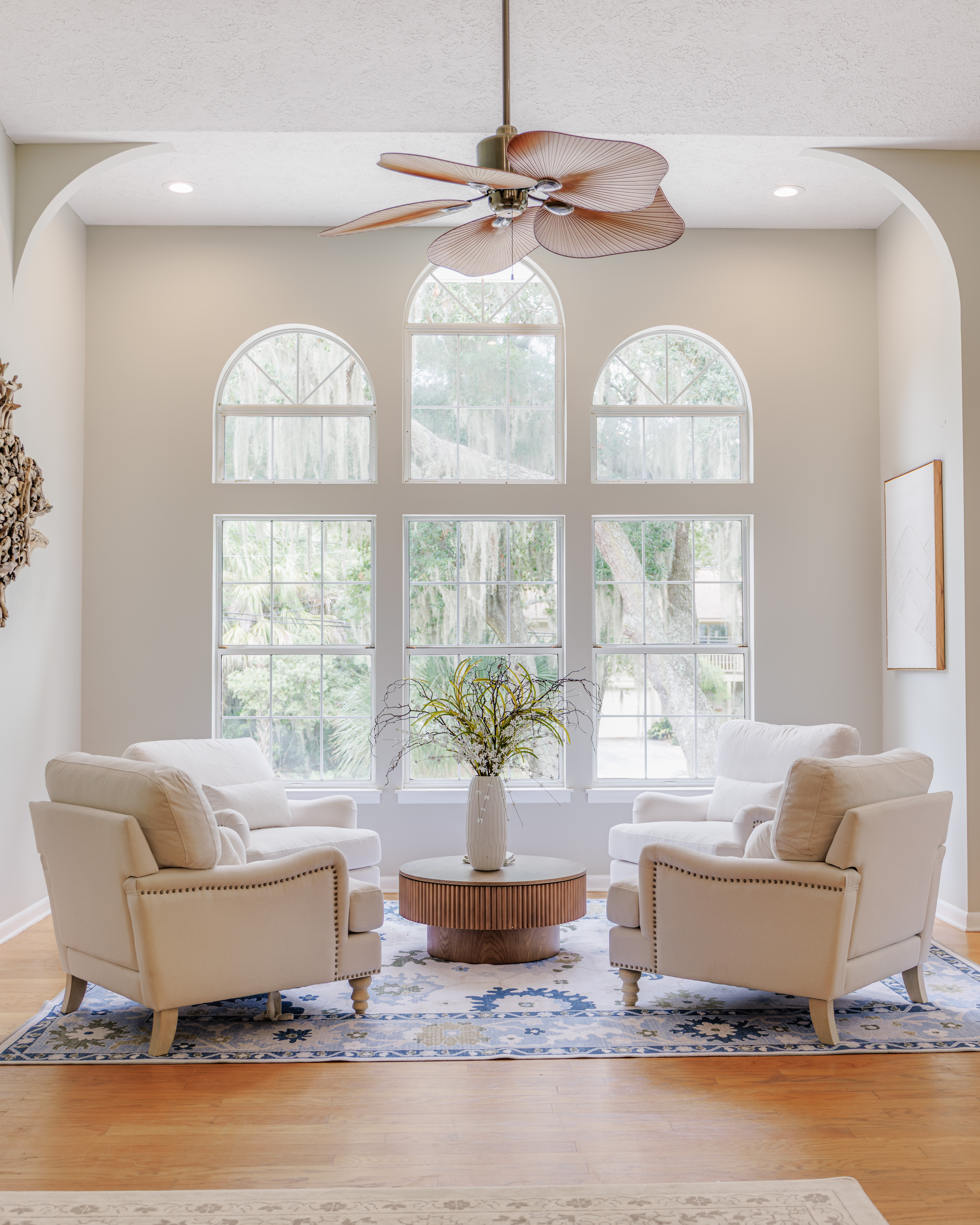 Styled coastal living room in a short-term rental with linen sofa and woven textures