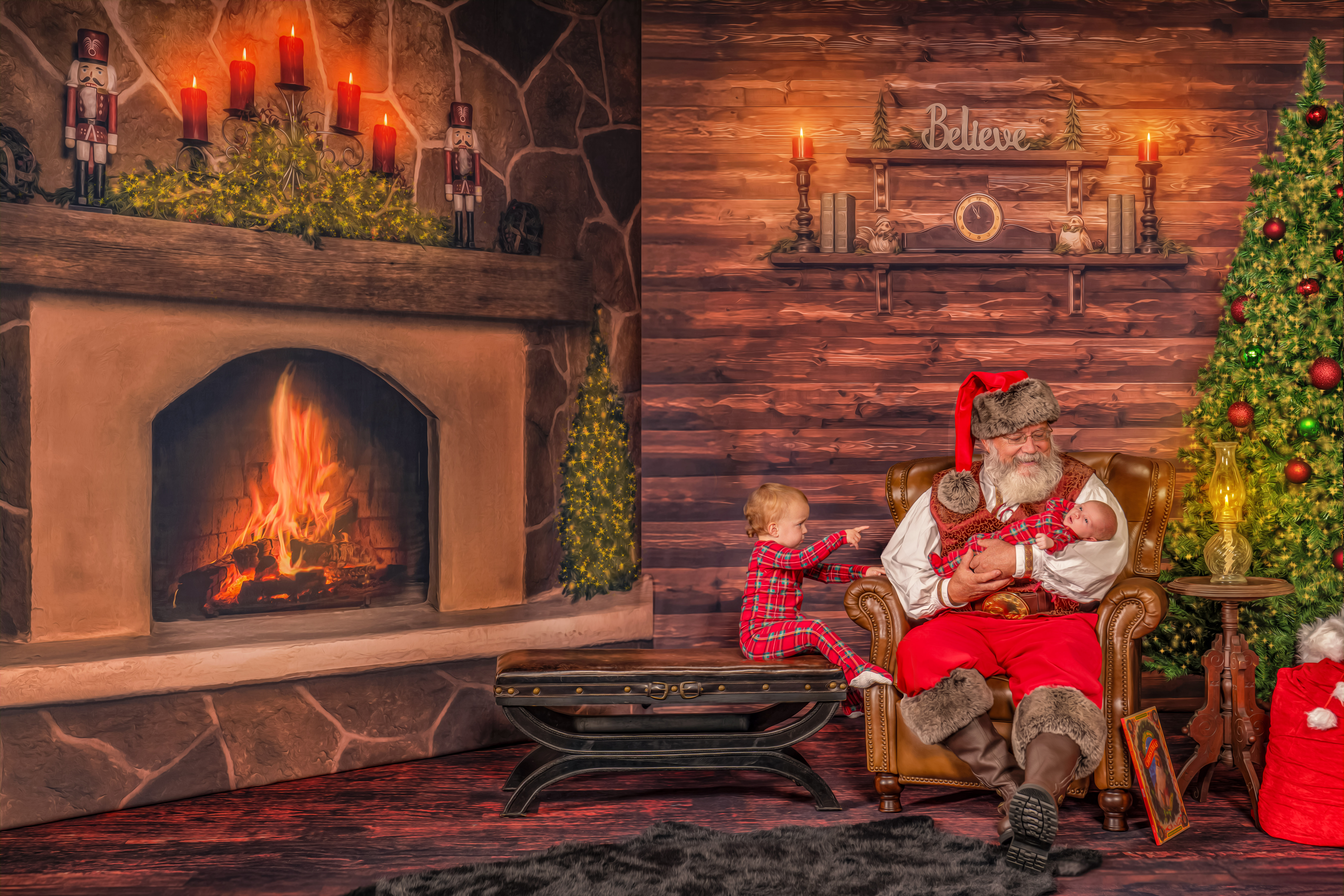 Santa Jay holding the baby while talking to big sister during The Magic of Santa experience