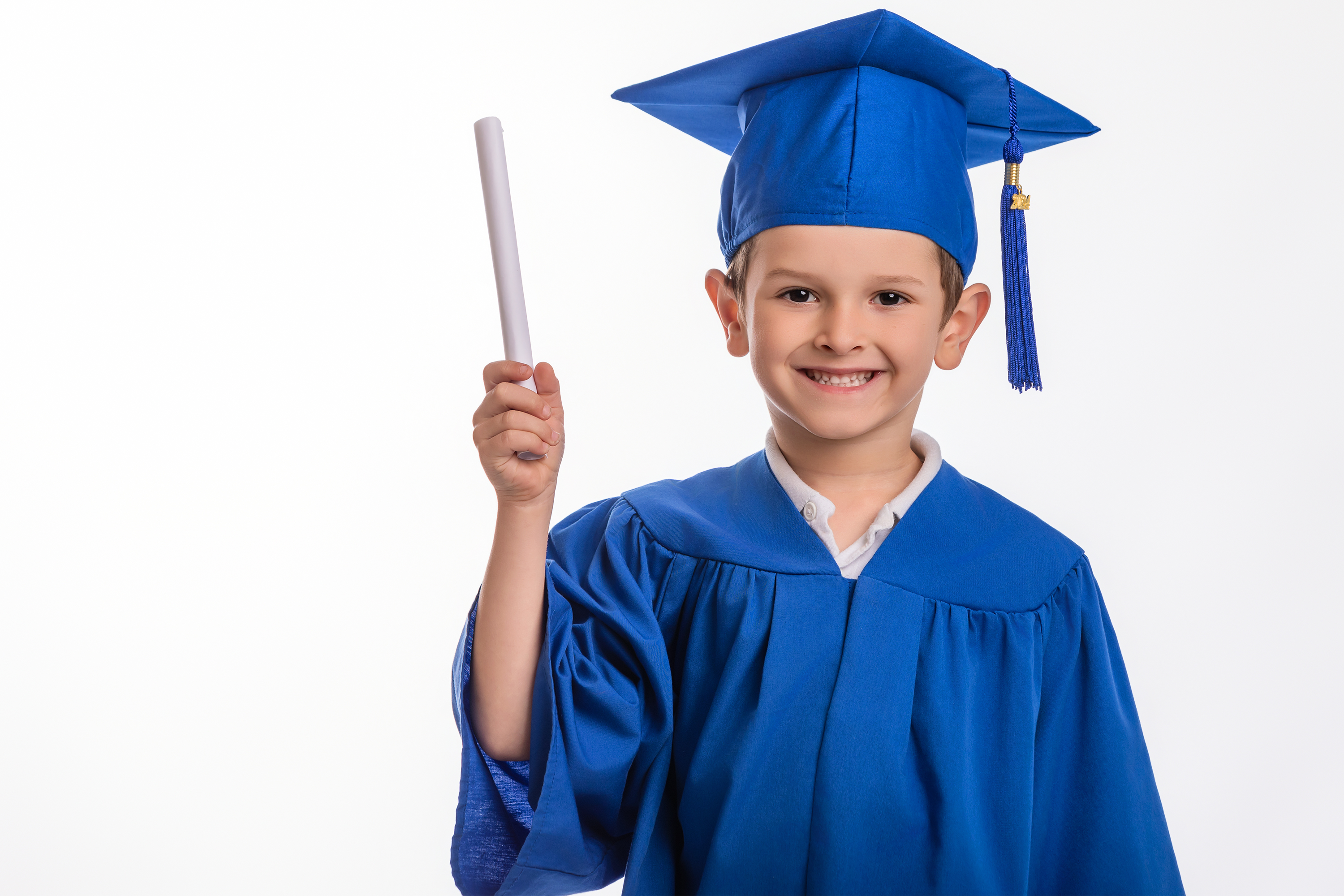 A preschool graduate holding his diploma during Swansboro UMC Childcare Spring photos