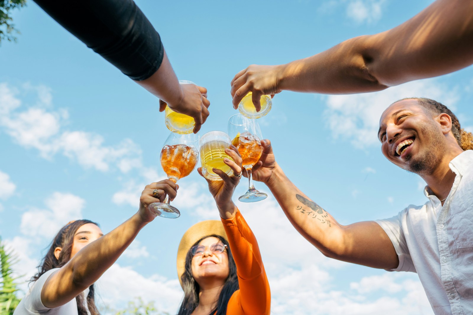 Friends raising their glasses together outdoors