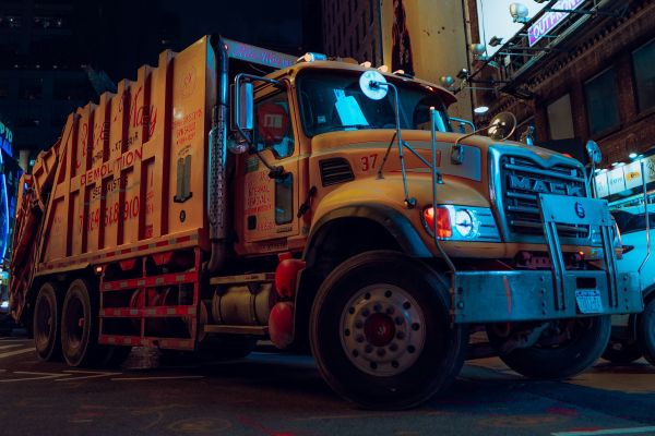 large yellow trash truck