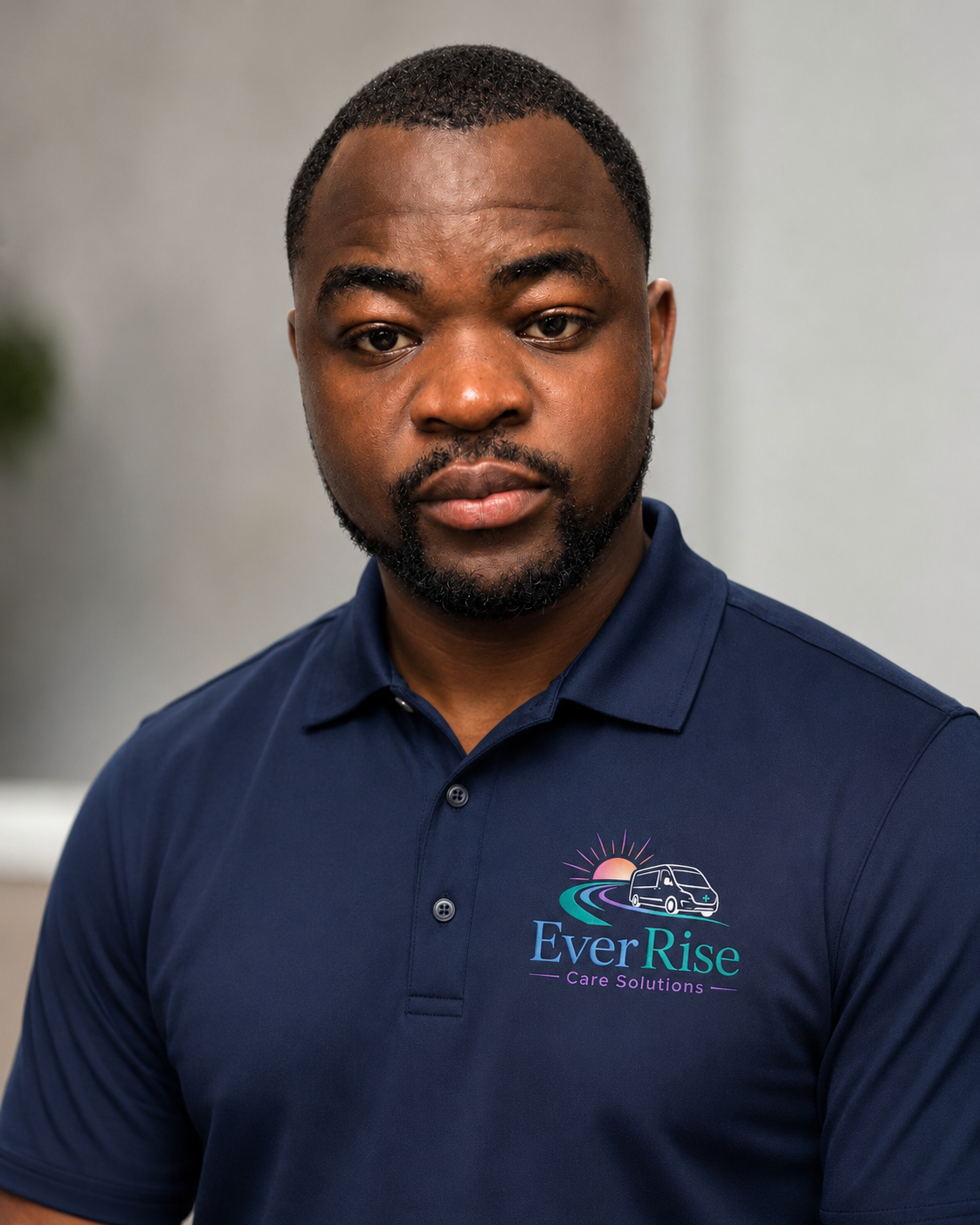 Joseph Ndayisaba, founder of EverRise Care Solutions, in an EverRise branded polo