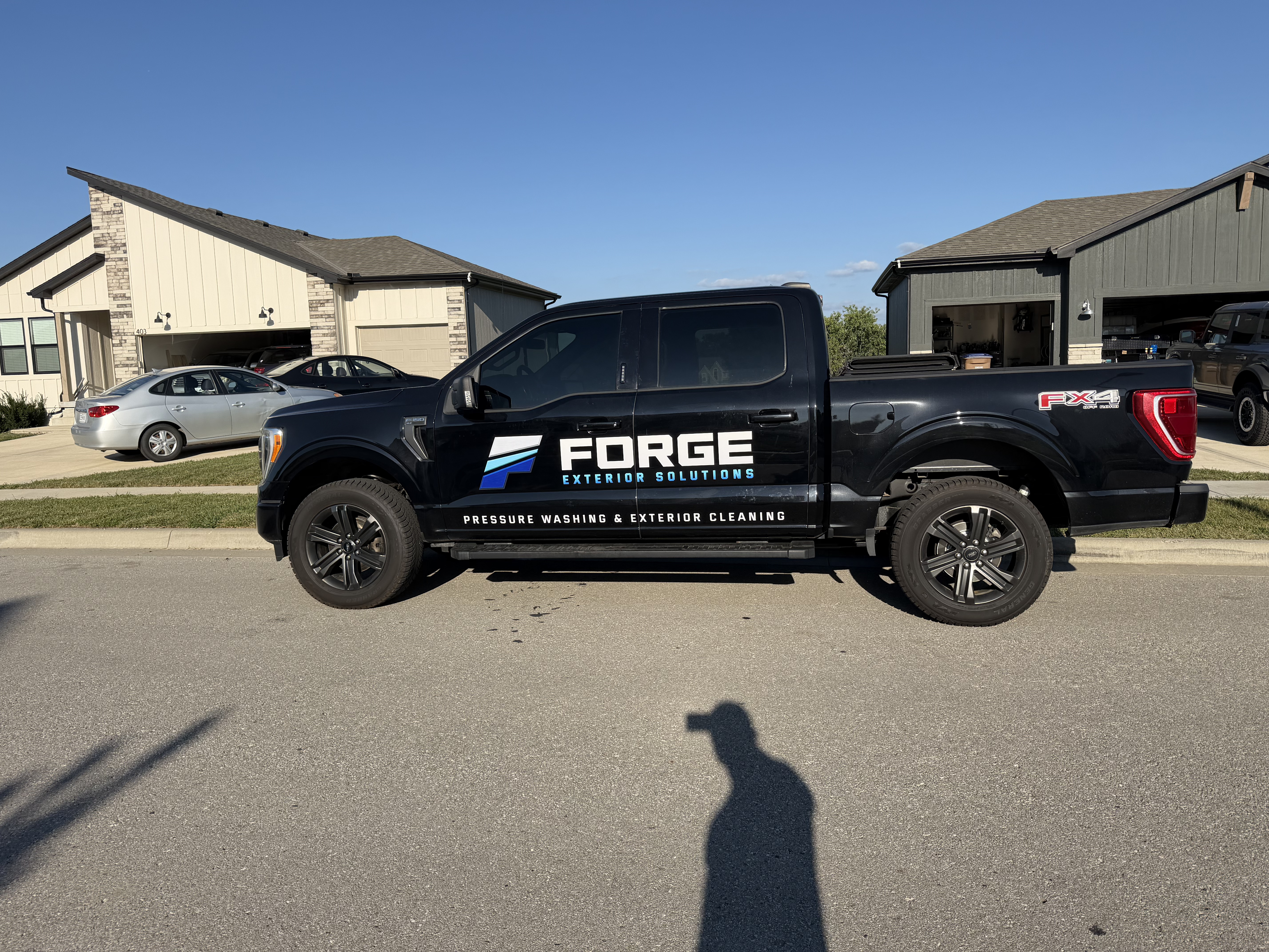 The Forge Exterior Solutions work truck and trailer on a job