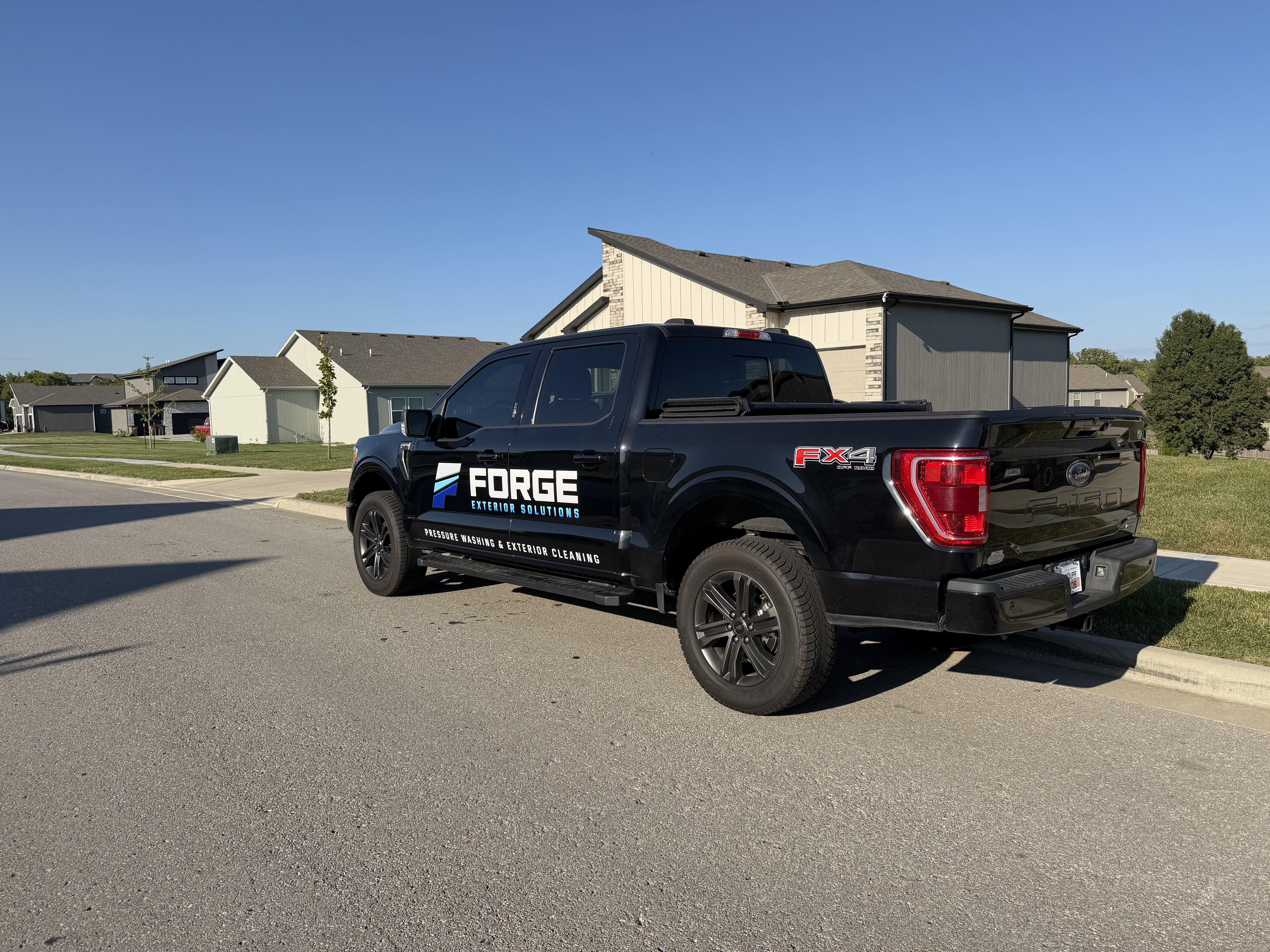 The Forge Exterior Solutions truck and trailer setup