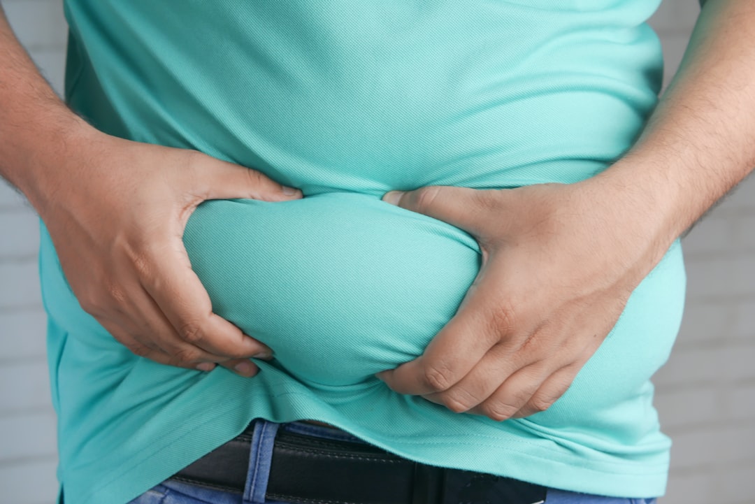 Man pinching belly fat.