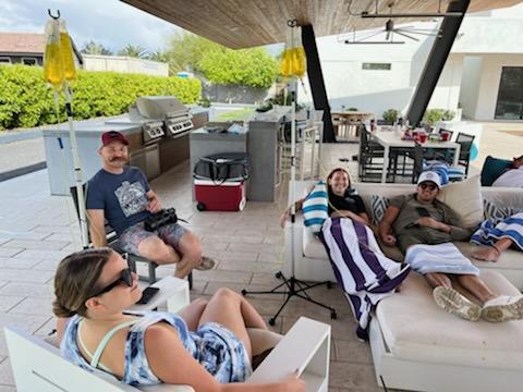 Group relaxing outdoors during IV therapy.