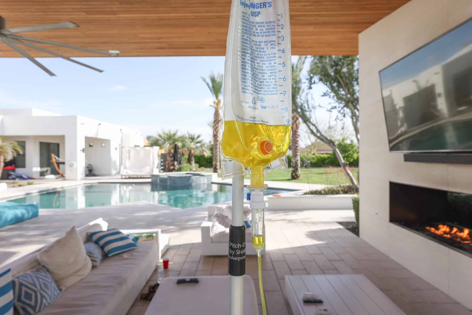 IV drip bag hanging near poolside patio.
