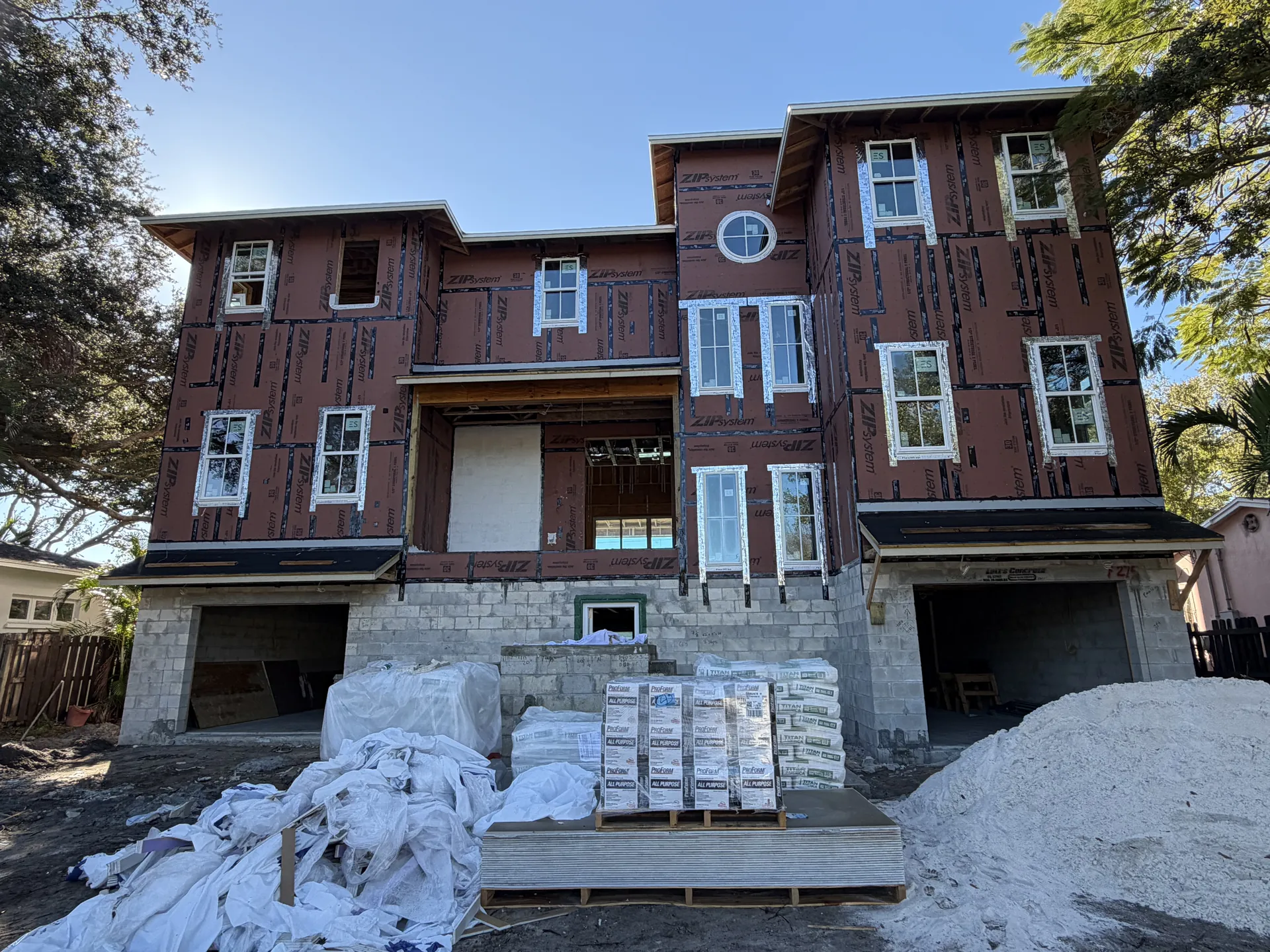 Three-story coastal residence at dry-in, masonry base with wood framing and sheathing above