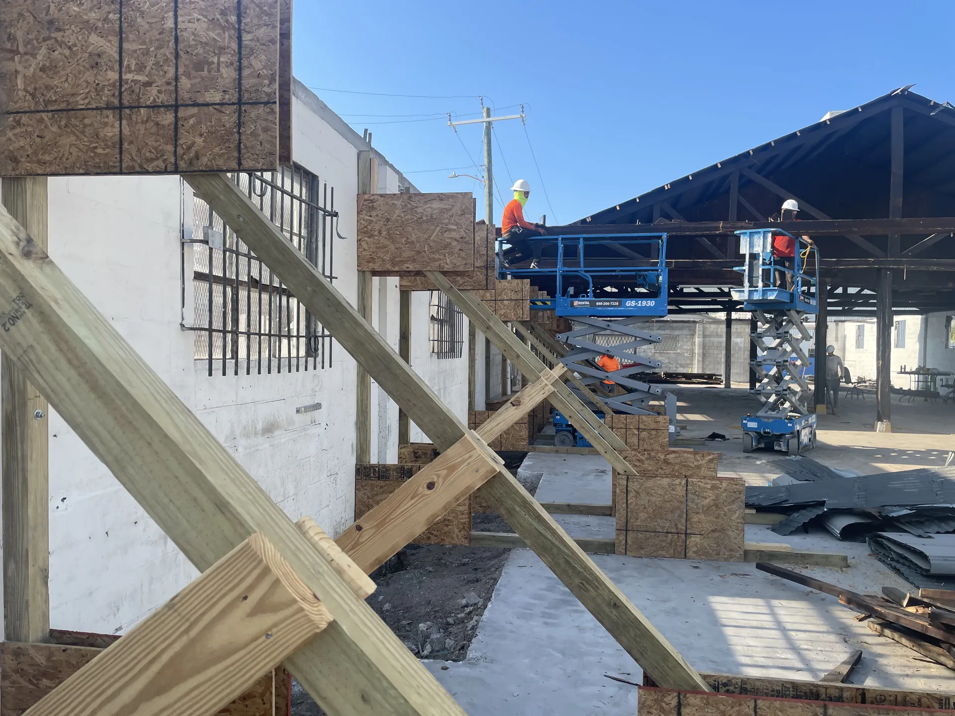 Duran Structural crews on lifts installing temporary bracing during a structural review