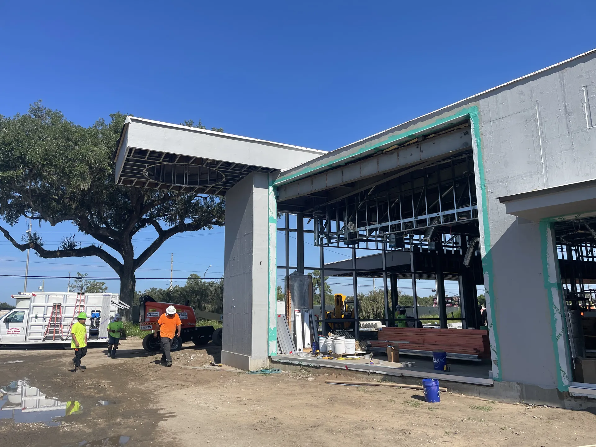 Steel-framed commercial building under construction in Florida, crews on site