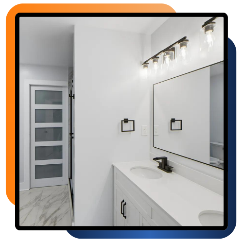 Updated bathroom with double vanity and bright mirror lighting