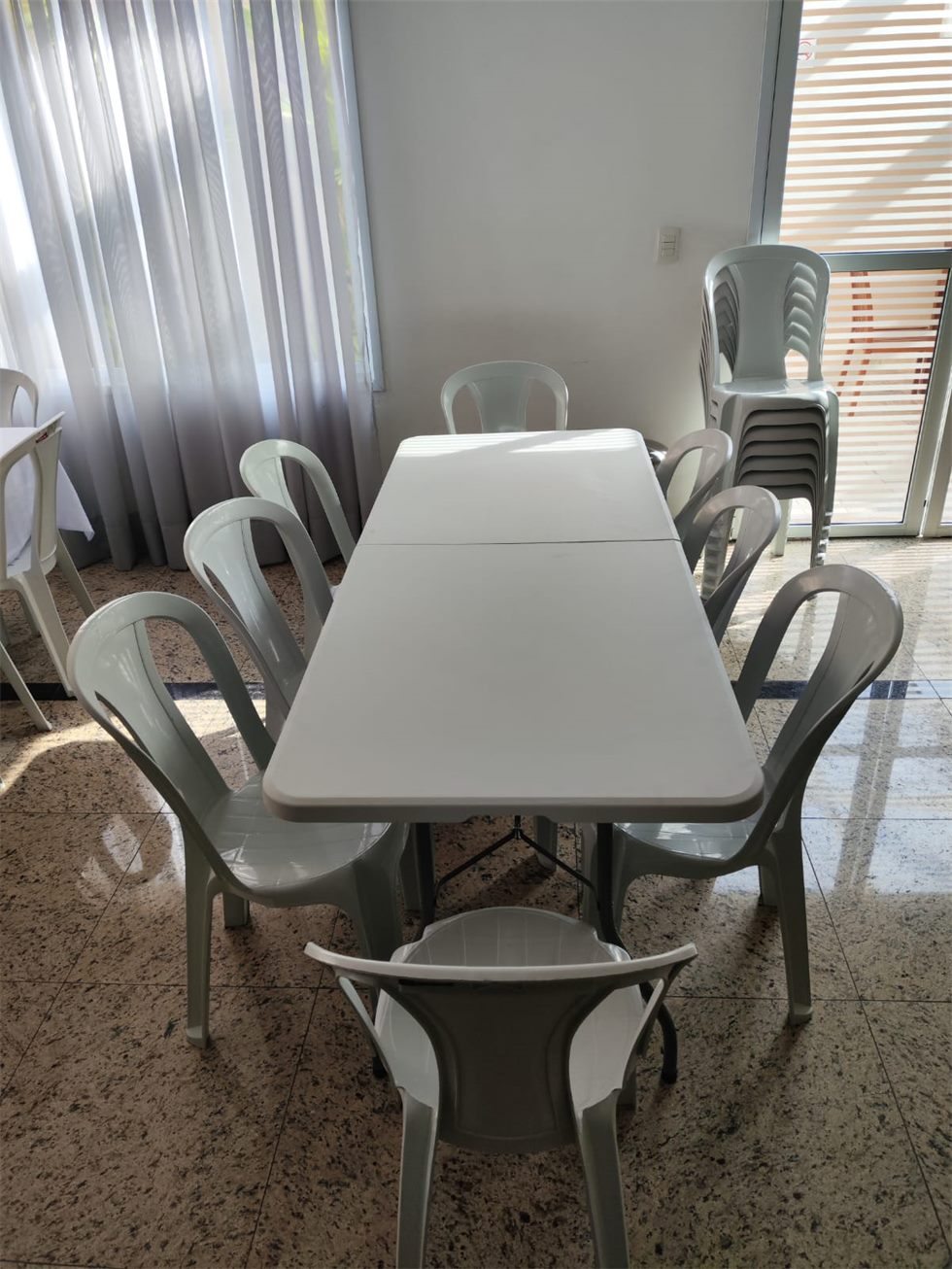 Mesa retangular com cadeiras plásticas para locação