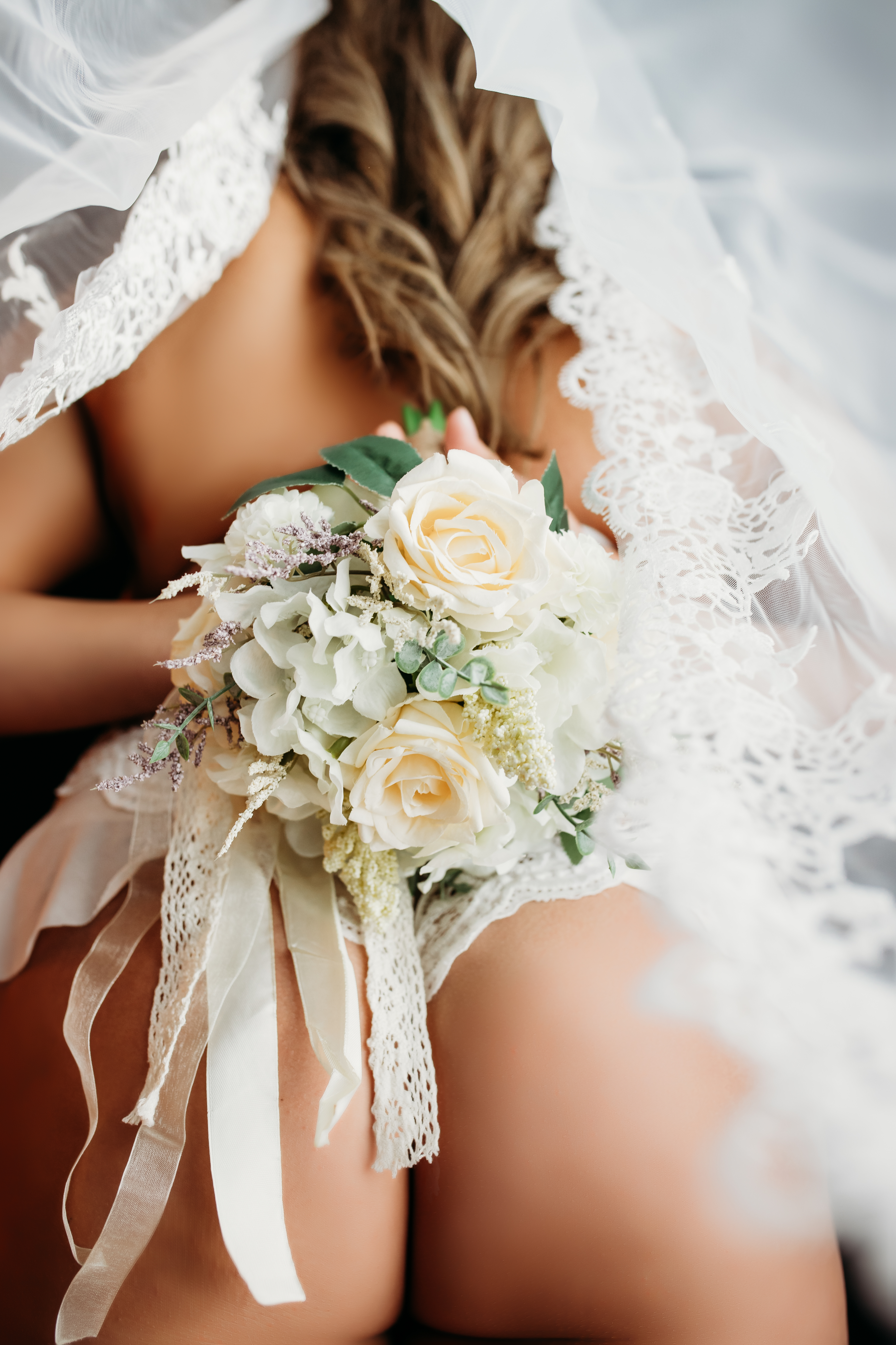 Bridal boudoir studio environment with veil and soft editorial light