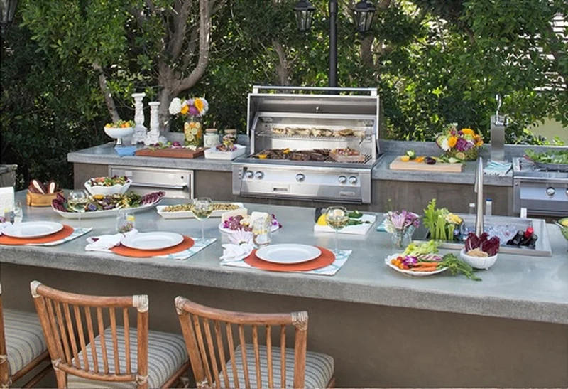 Finished outdoor kitchen with a set table ready for guests