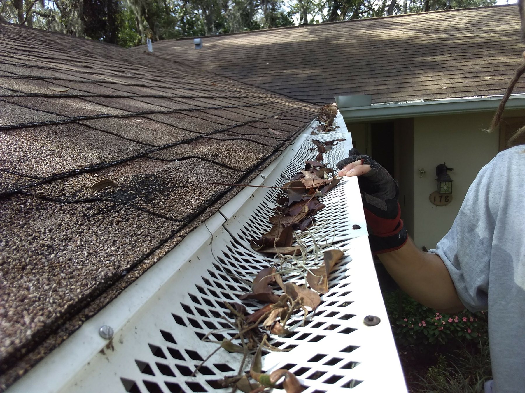 Cheap plastic gutter guards screwed down through the roof shingles, damaging the roof and fascia
