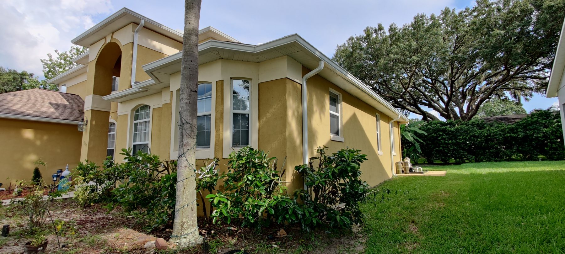Wide view of a Mediterranean-style Tampa Bay home finished with Trufam gutters and guards