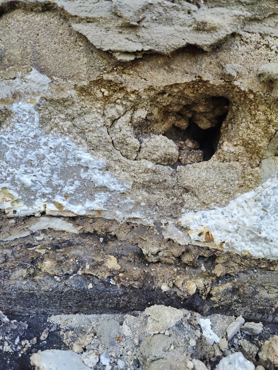 Large hole found in a foundation wall, filled with hydraulic cement before waterproofing by Trufam Drainage in Tampa Bay