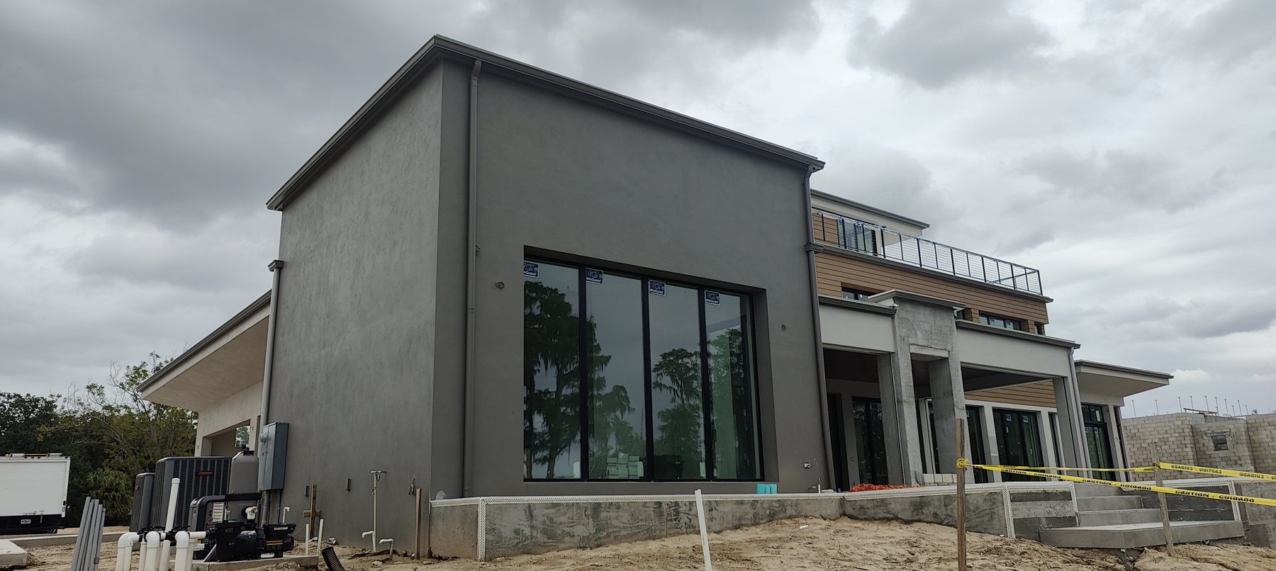 Modern two-story luxury home with a rooftop deck in Tampa Bay, gutter system by Trufam Drainage