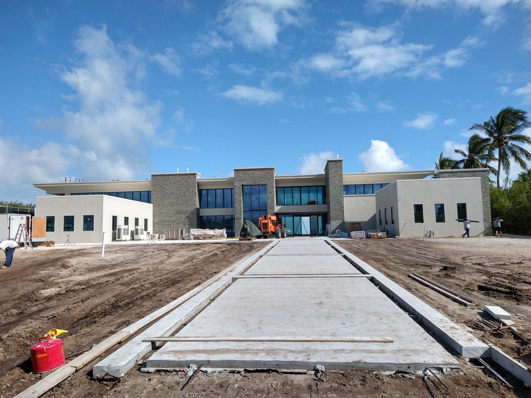 Walkway approach to a new white luxury home in Tampa Bay with Trufam on the gutter package