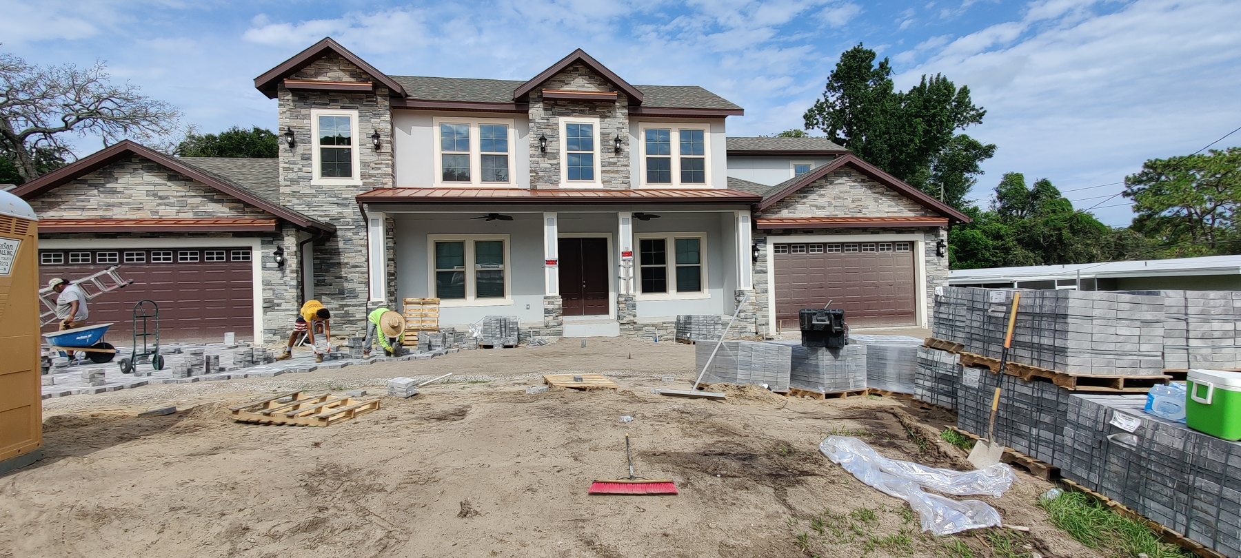 Craftsman-style new build with stone accents in Tampa Bay, gutters by Trufam Drainage