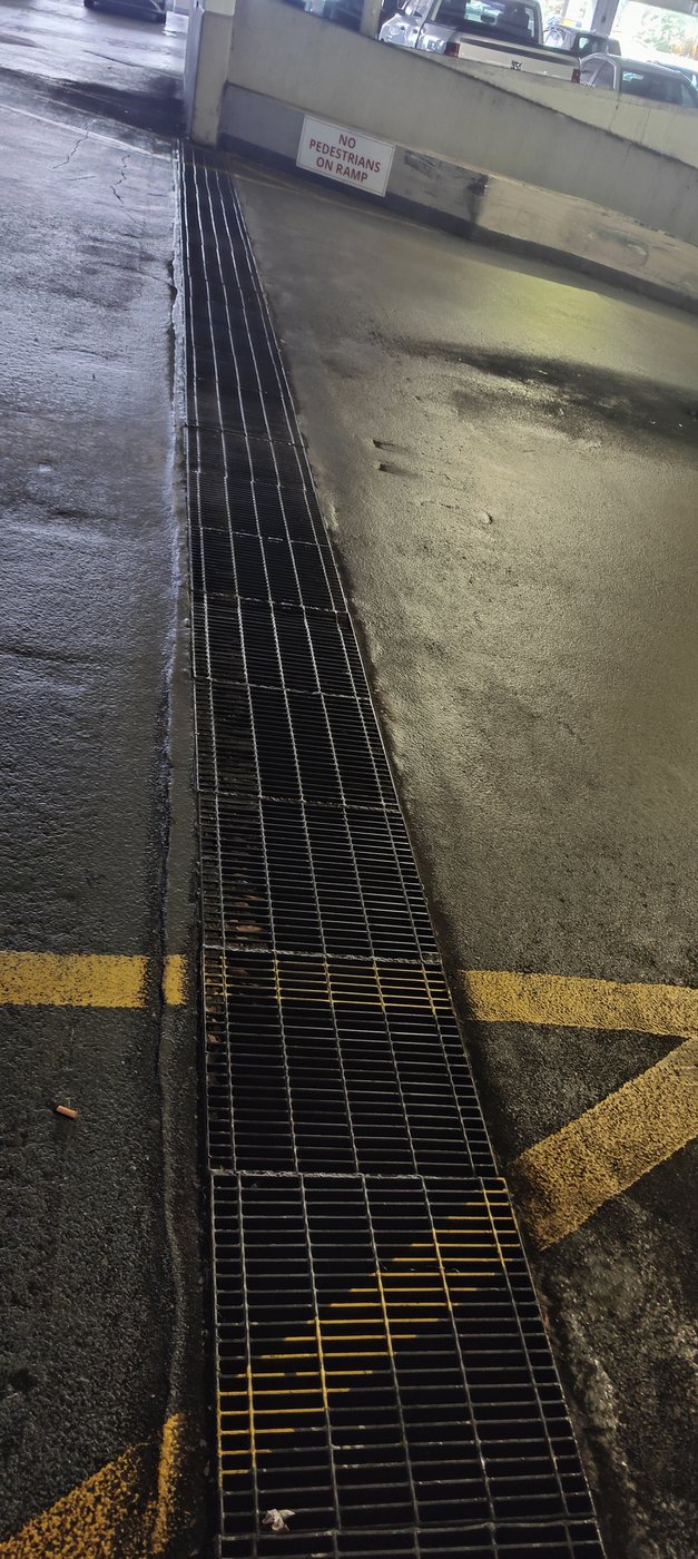 Trufam cleaning a commercial parking garage trench drain in Tampa Bay