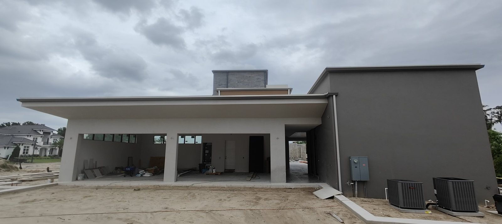 A long custom commercial gutter run along the eave of a modern Tampa Bay building