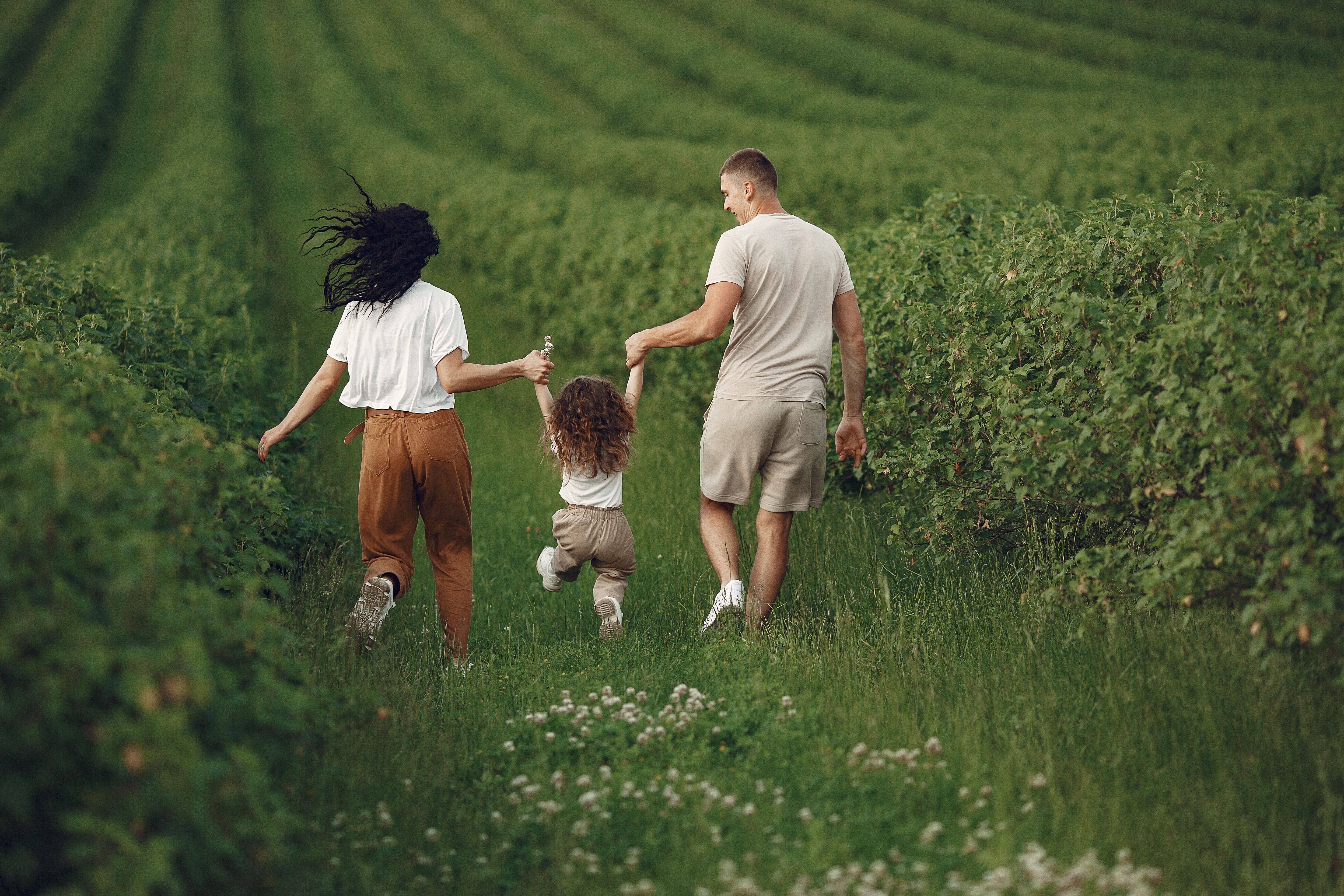 Family of three on a grass field