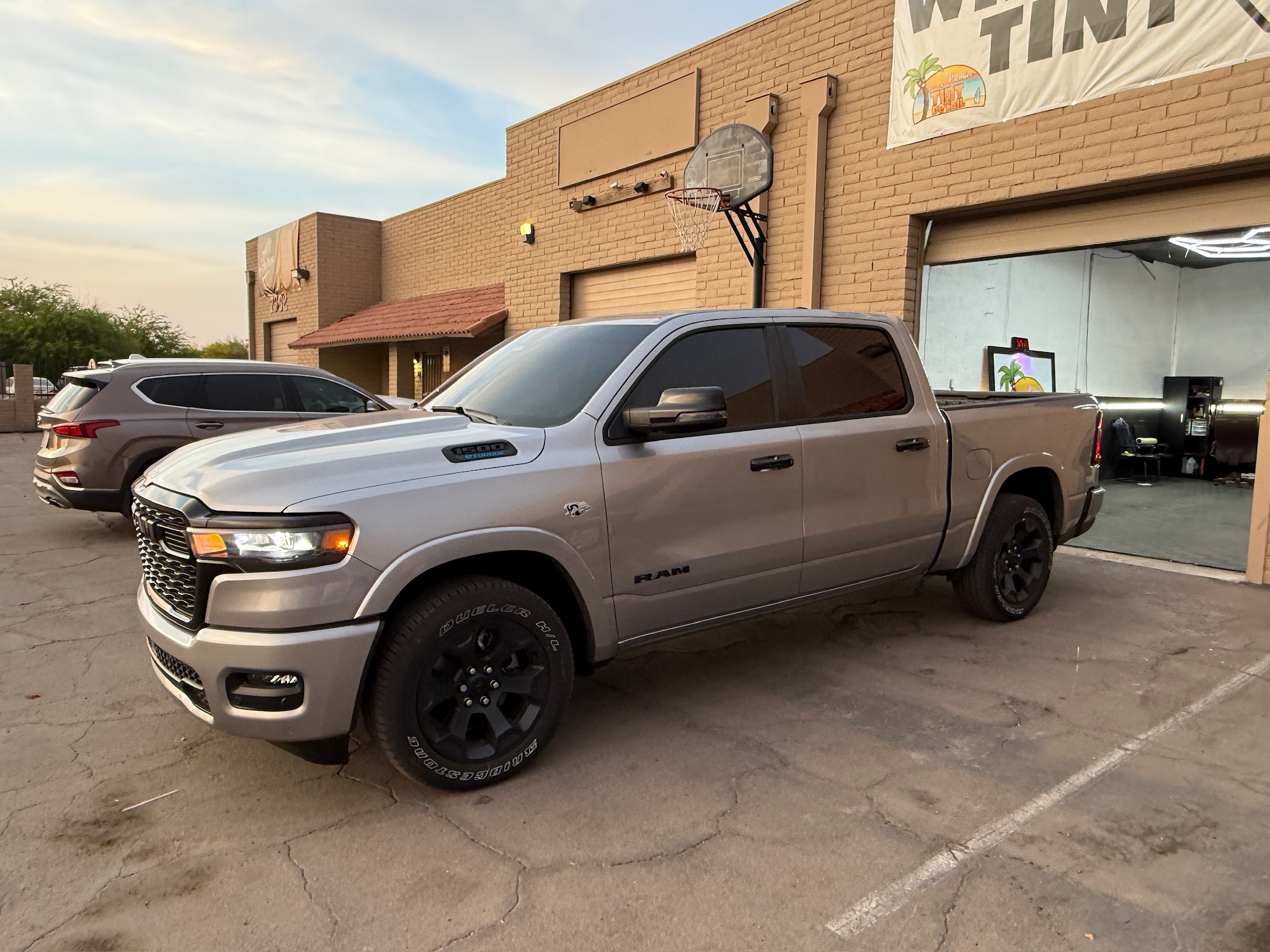 Premier Tint & Wrap shop work bay with finished vehicles