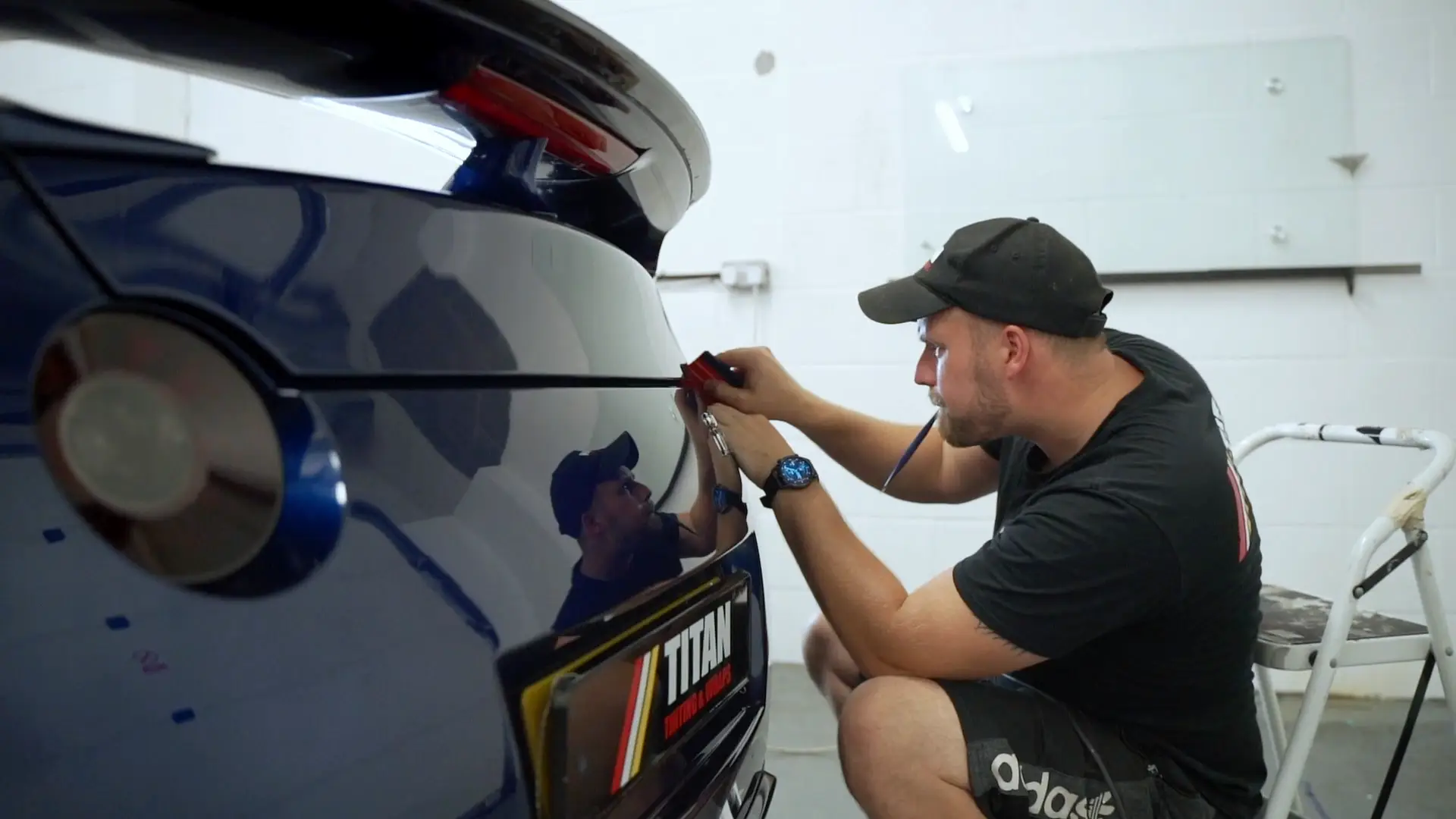 Titan installer dechroming the rear of a car in the Peterborough workshop