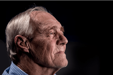 A senior man, looking concerned about his eye health
