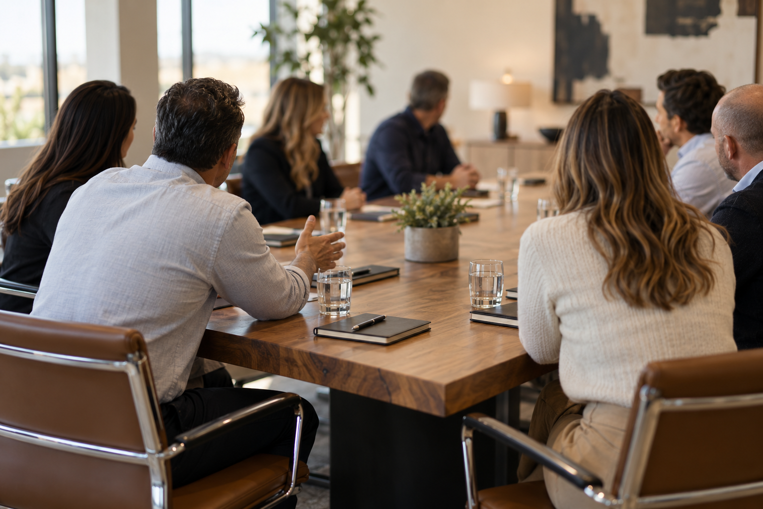 Dallas-Fort Worth business owners seated around a conference table during a monthly peer advisory board session, seen from behind.