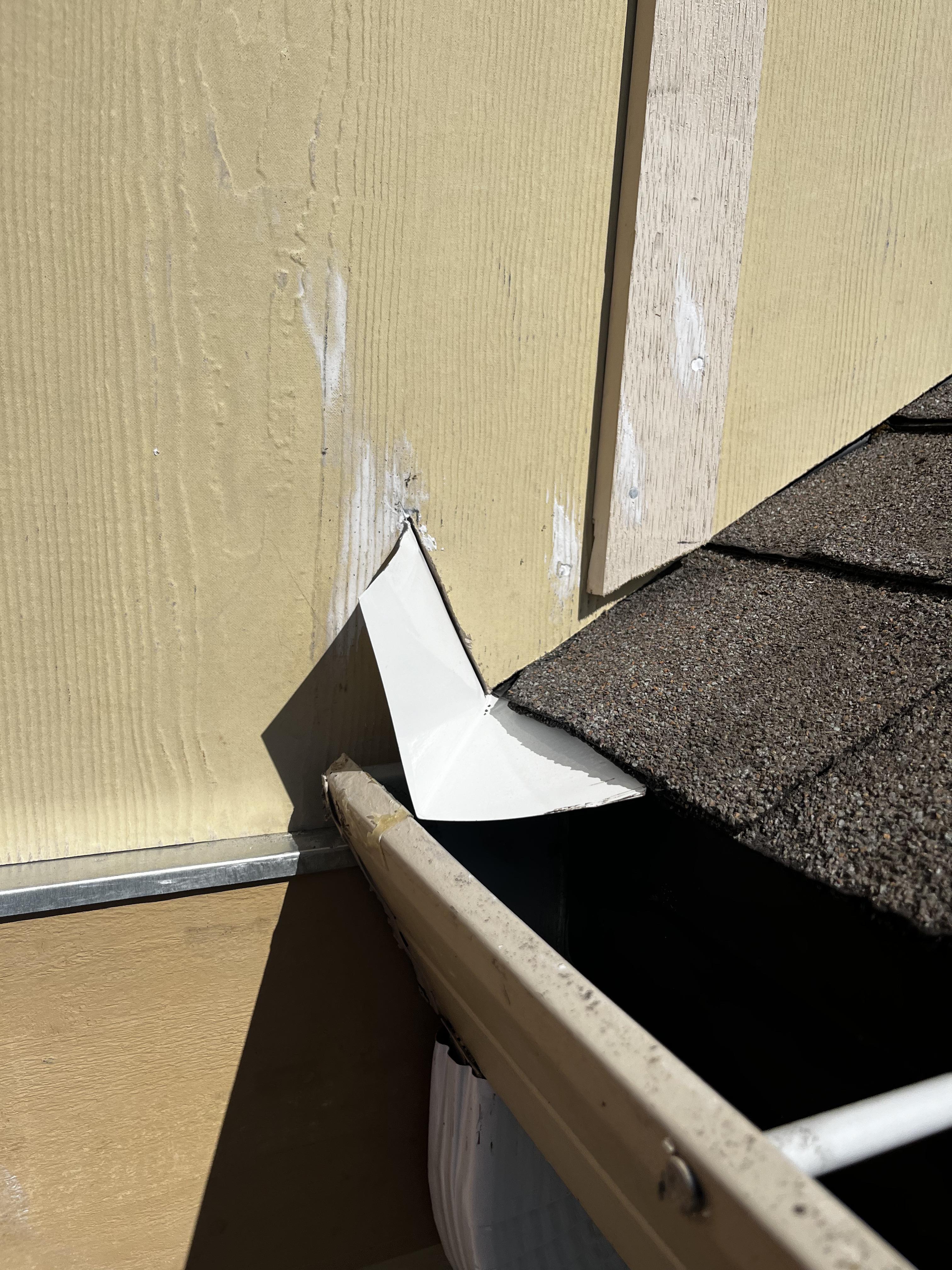 Repaired gutter with kickout flashing