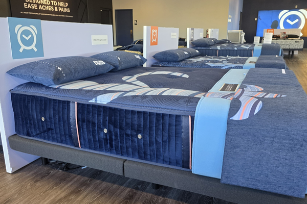 Row of premium Stearns & Foster mattresses with pillows on display at Snooze Mattress + Wellness East El Paso, featuring Dream Mapping Technology for comfort and pain relief.