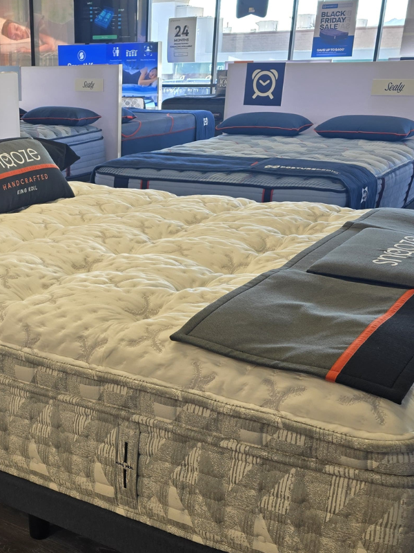 Showroom display of premium mattresses at Snooze Mattress + Wellness East El Paso, featuring brands like Sealy and Tempur, highlighted during the Black Friday sale.