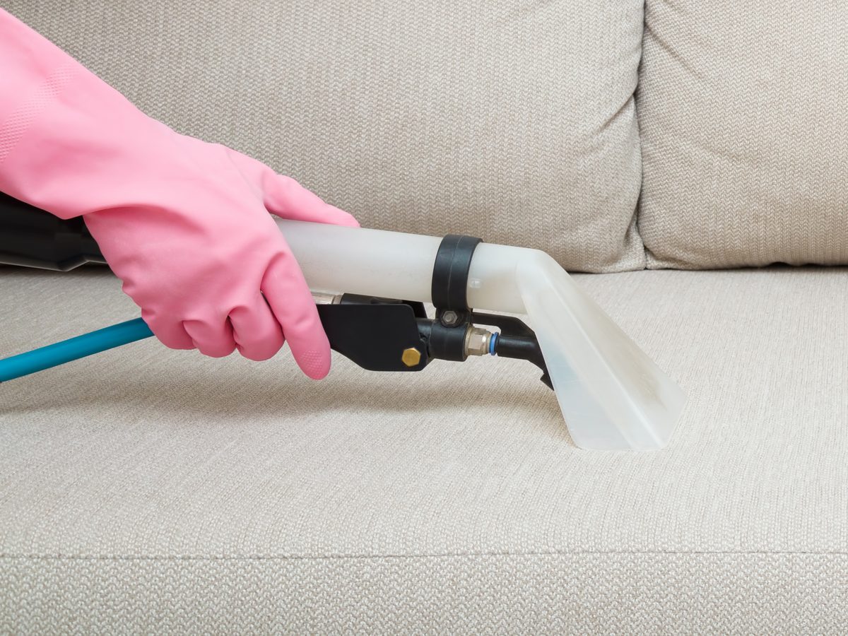 Upholstery cleaning tool on a fabric sofa