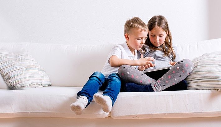 Kids on a clean white sofa