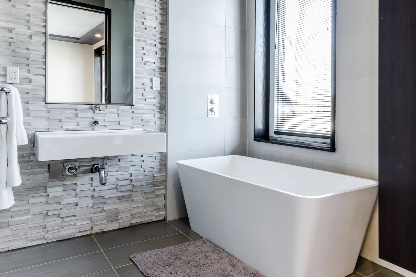 Modern gray bathroom renovation with glass shower