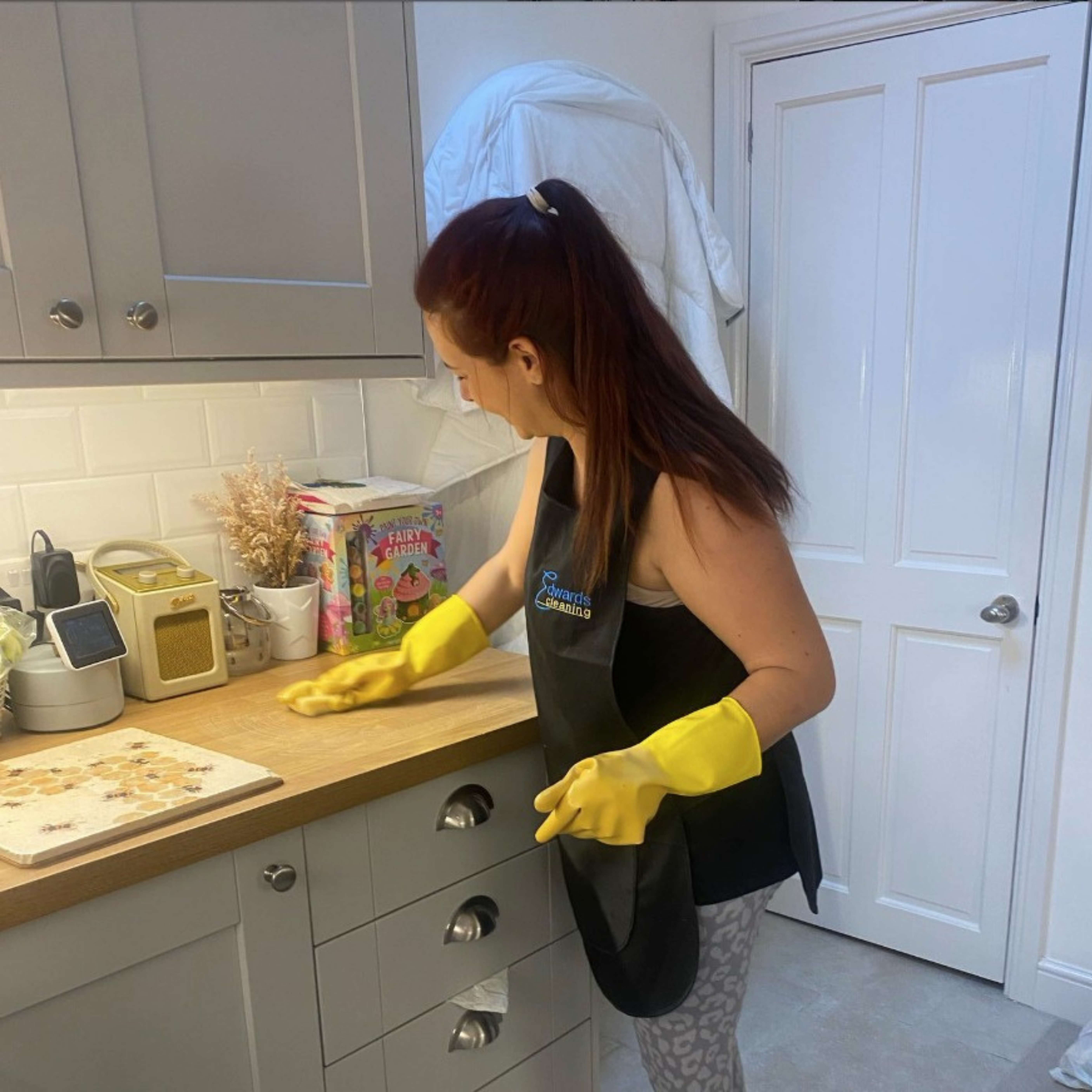 Edwards Cleaning professional wiping down a kitchen counter during a deep clean in Nottingham home