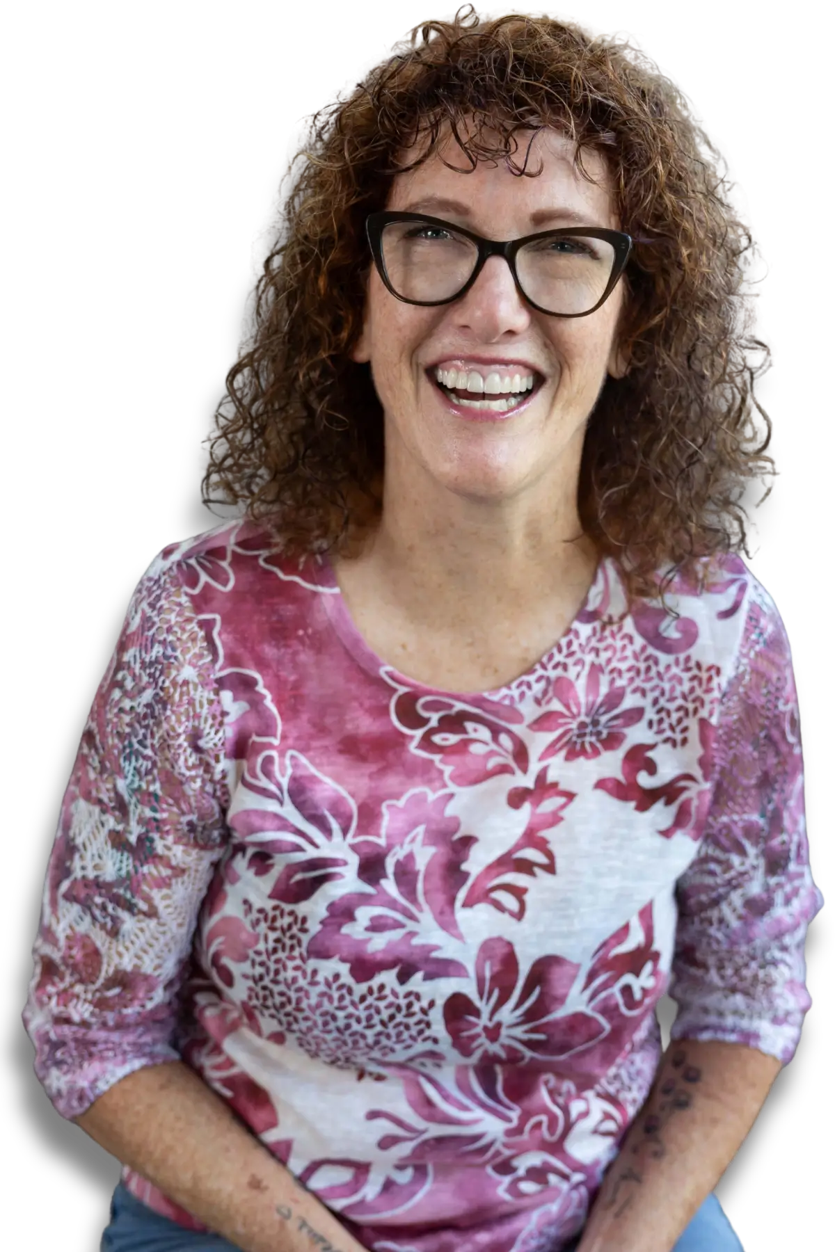 Katy Swanson smiling and laughing wearing a pink shirt
