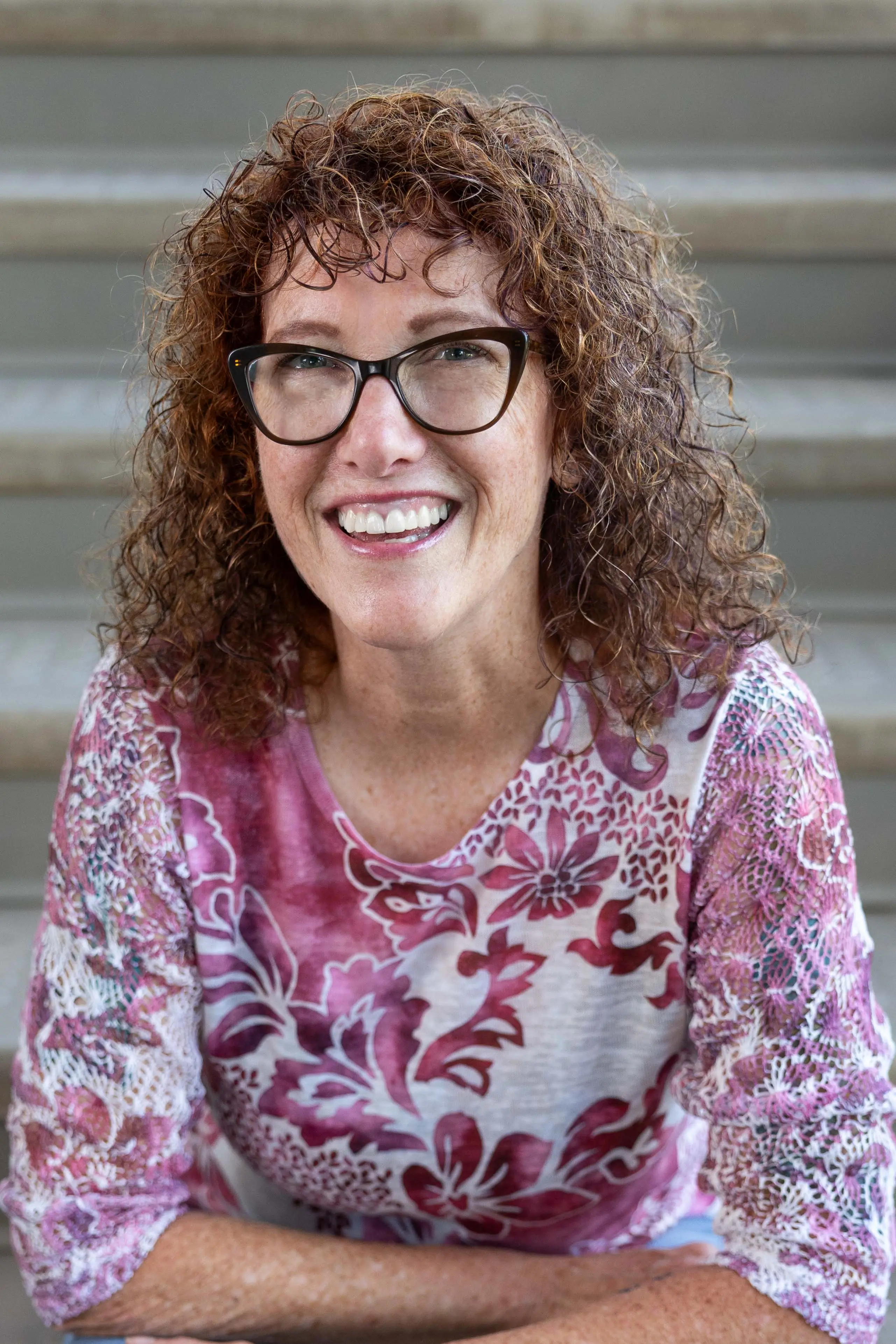 Katy Swanson sitting on steps smiling