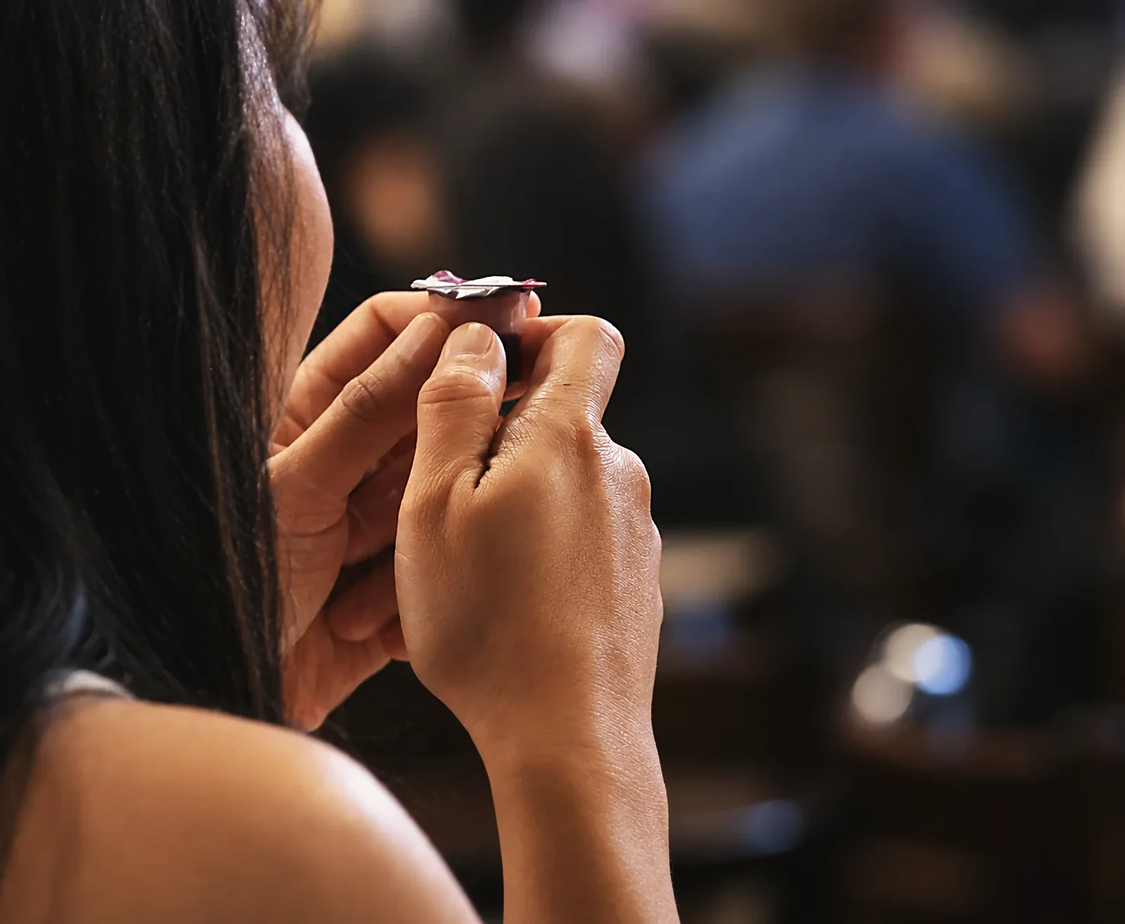 A woman holds the Communion cup during the service at The Village Church.