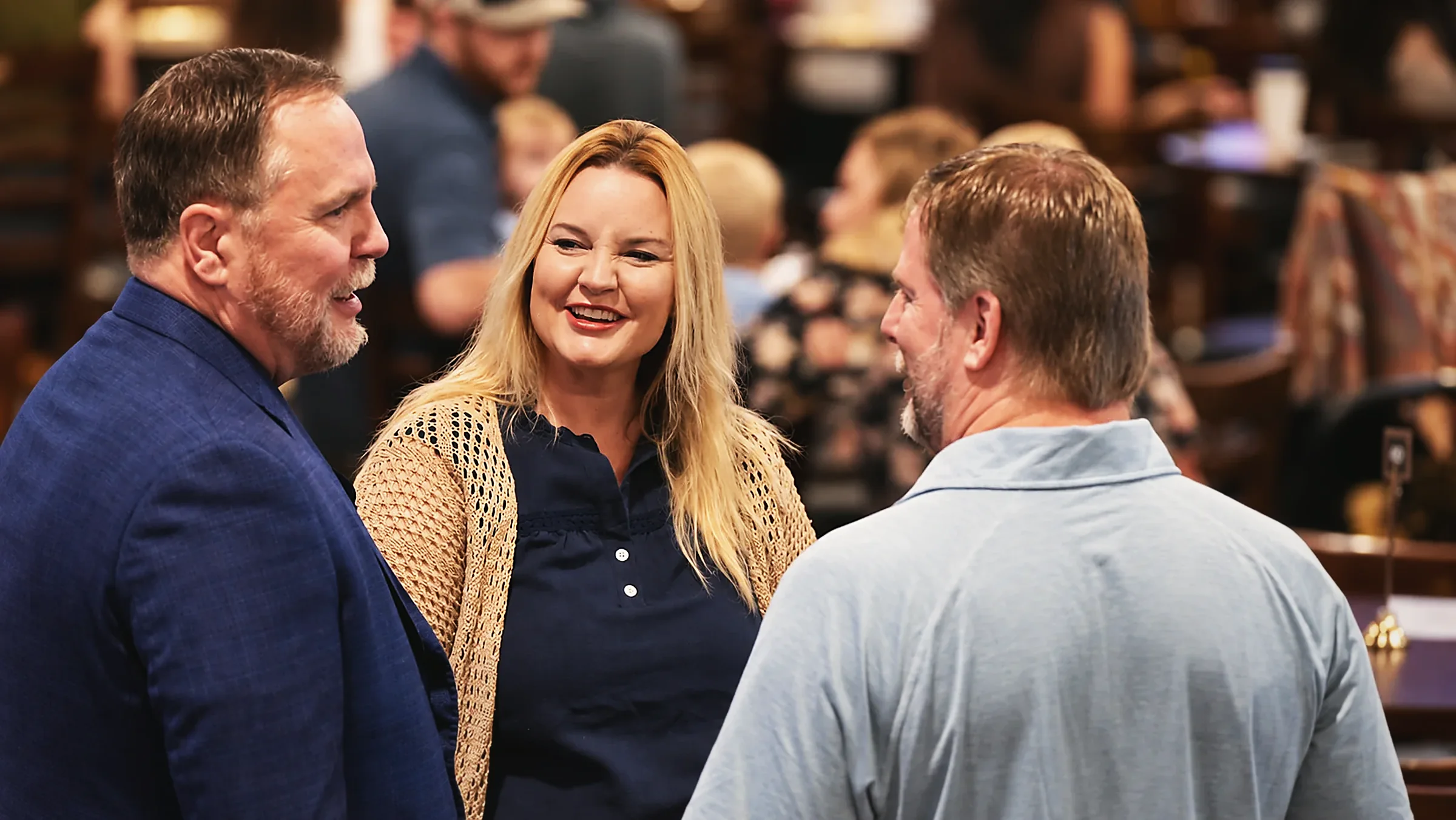 Pastor Brady Boyd talking with two people in the room at The Village Church.