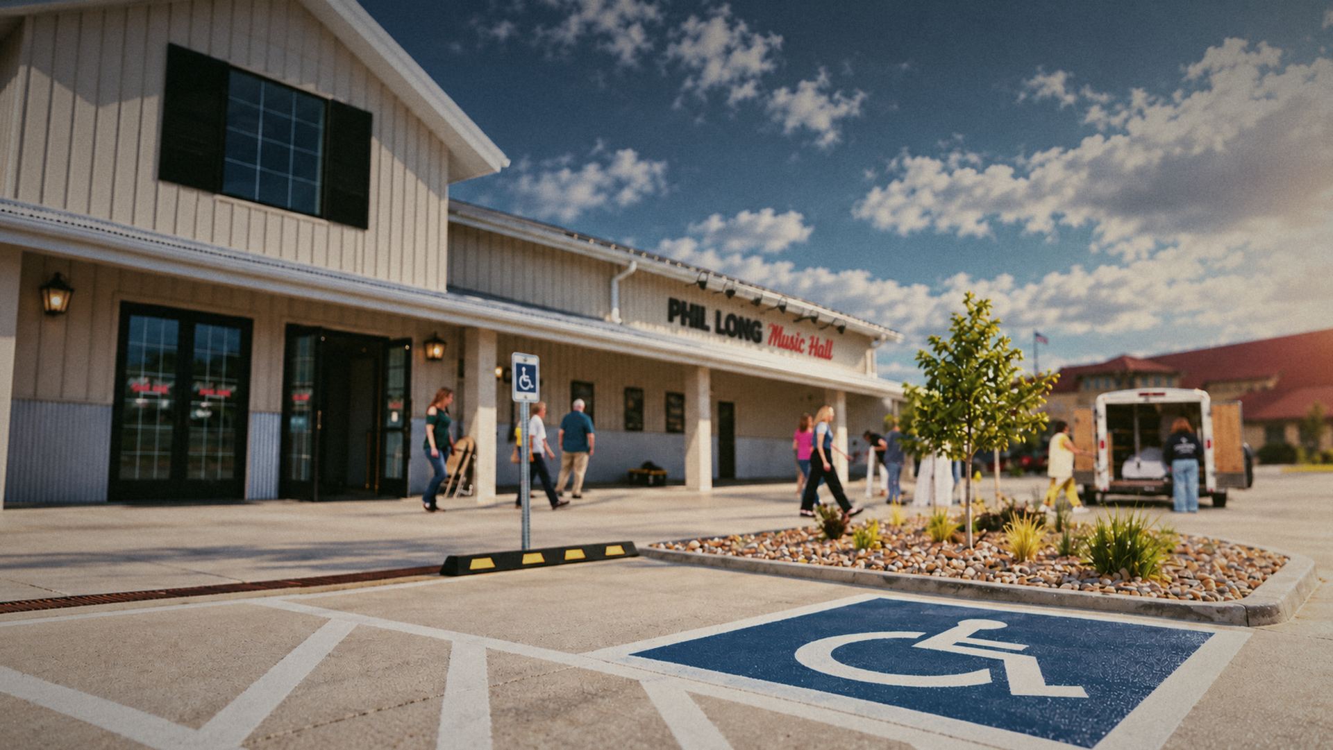 Accessible parking spaces and signs outside the ground-level entrance of Phil Long Music Hall
