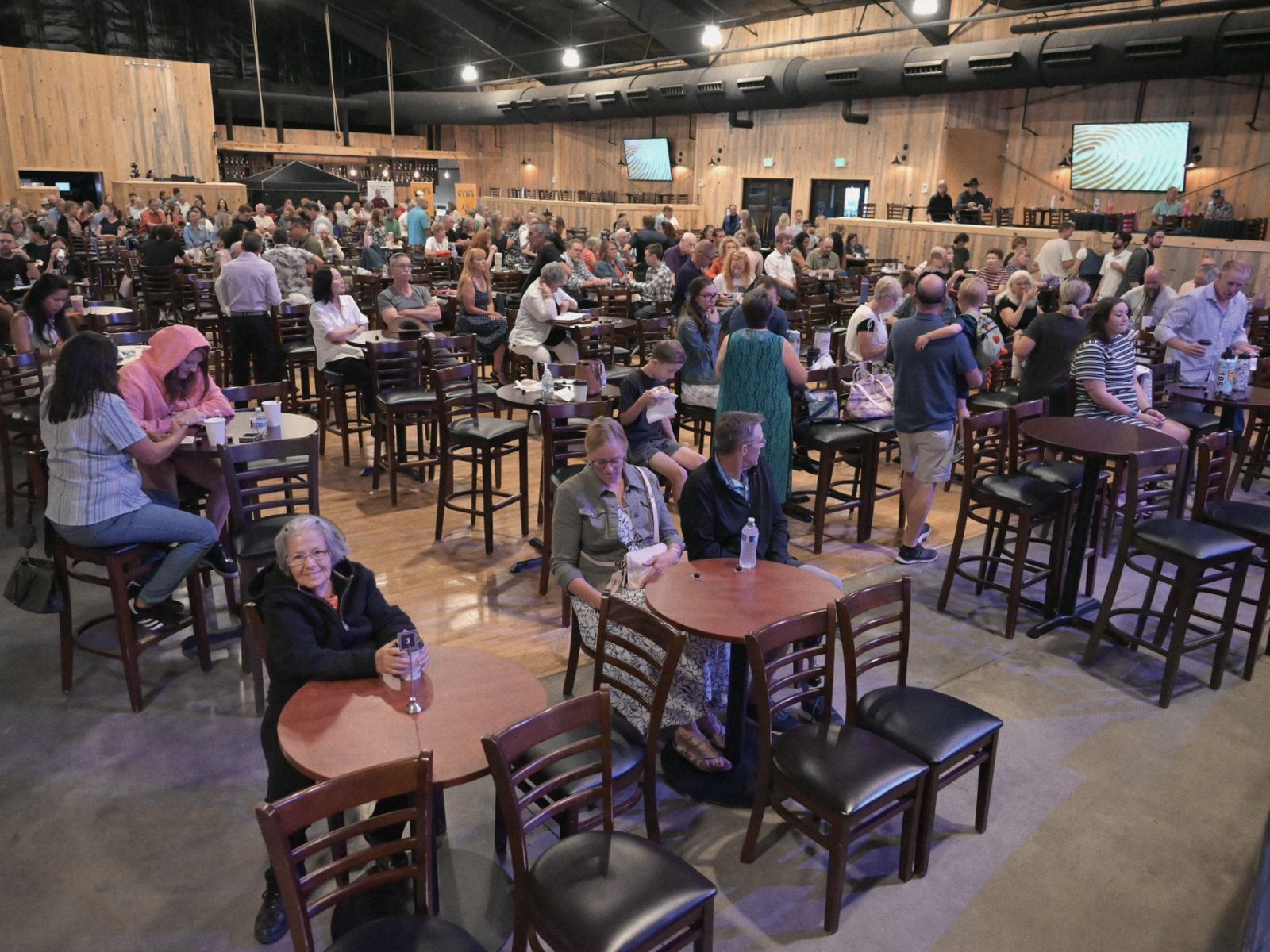The main room at Phil Long Music Hall with round tables, chairs, and high-top seating