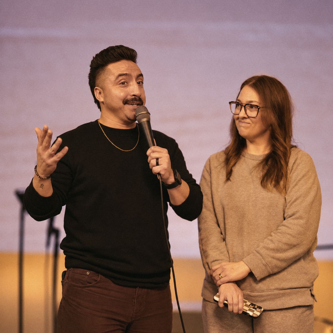 Pastors Joseph and Lindsay Rangel speaking together on stage at The Village Church