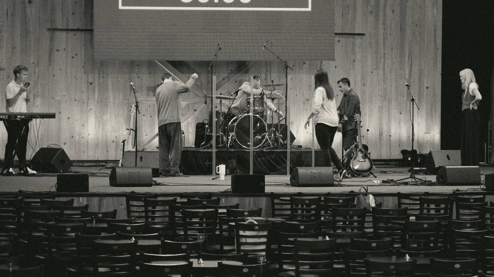 The Village Church worship team setting up on stage before a Sunday gathering