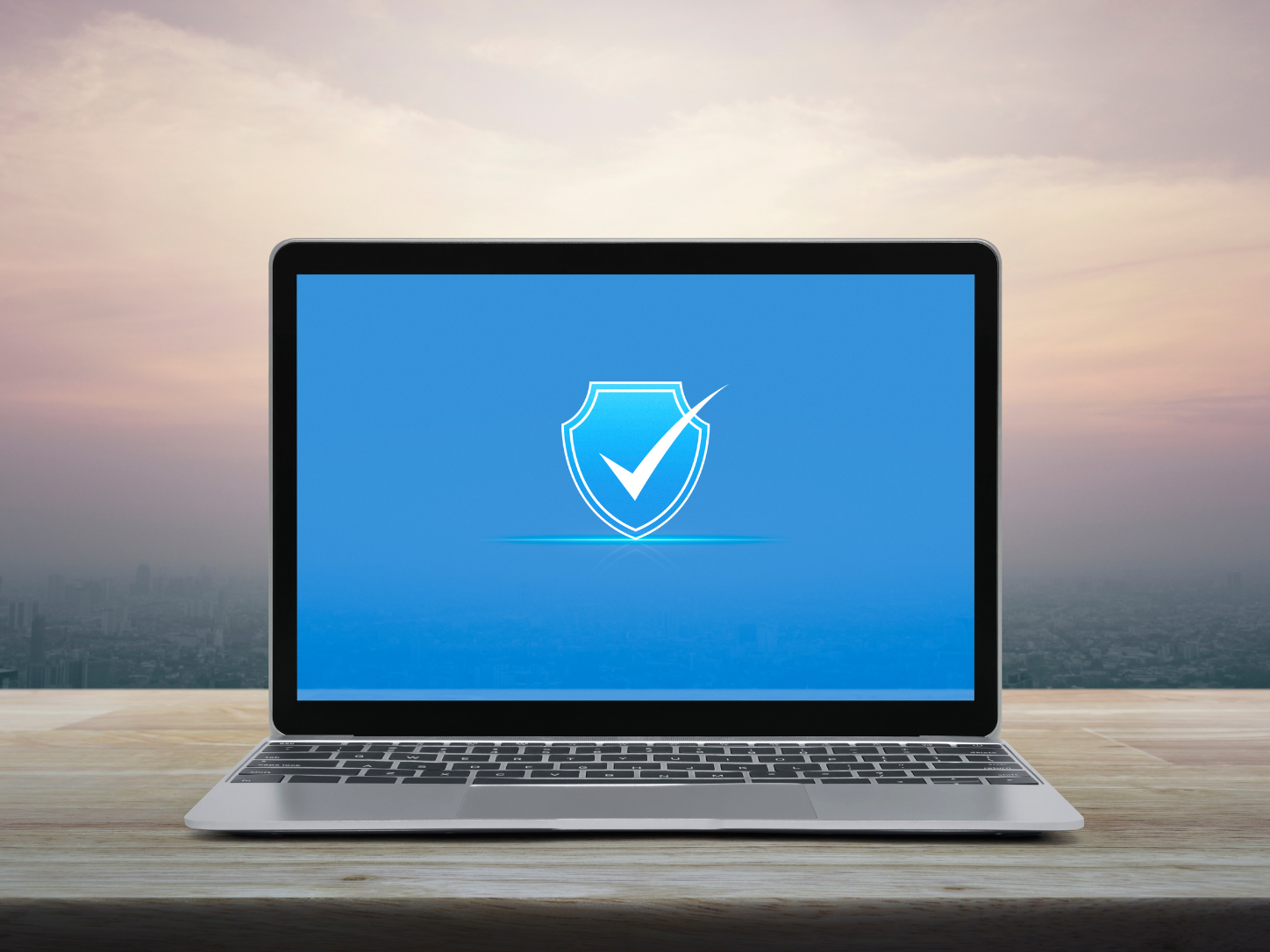 Laptop displaying a cybersecurity shield icon representing Cyber Shield, advanced business cybersecurity, 24/7 threat monitoring, endpoint protection, ransomware defense, and secure IT services for small businesses.