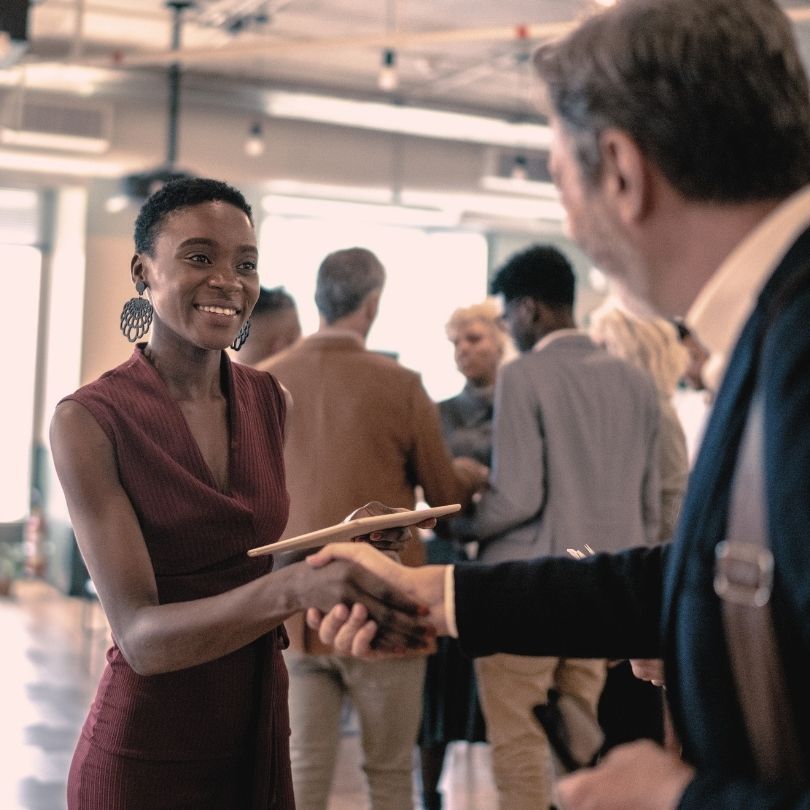 Two attendees shaking hands at the end of the evening after making a great connection