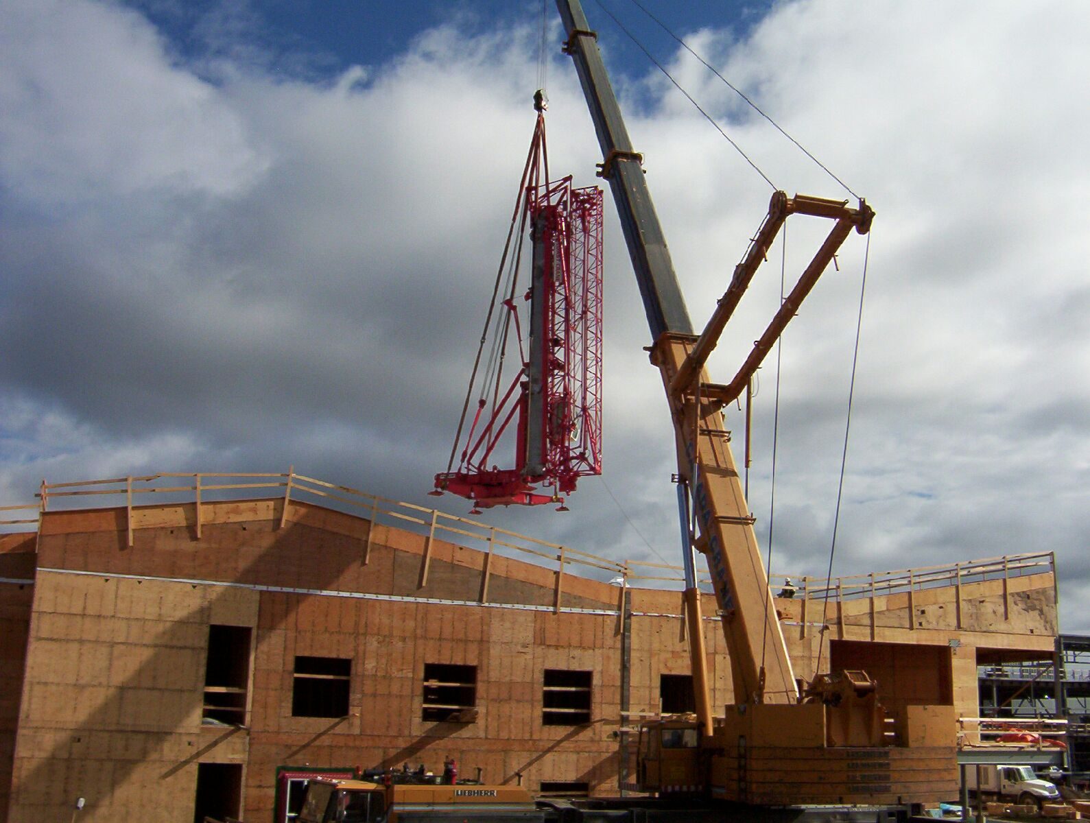 Oxford Crane mobile crane lifting a red tower crane section onto a Toronto construction site