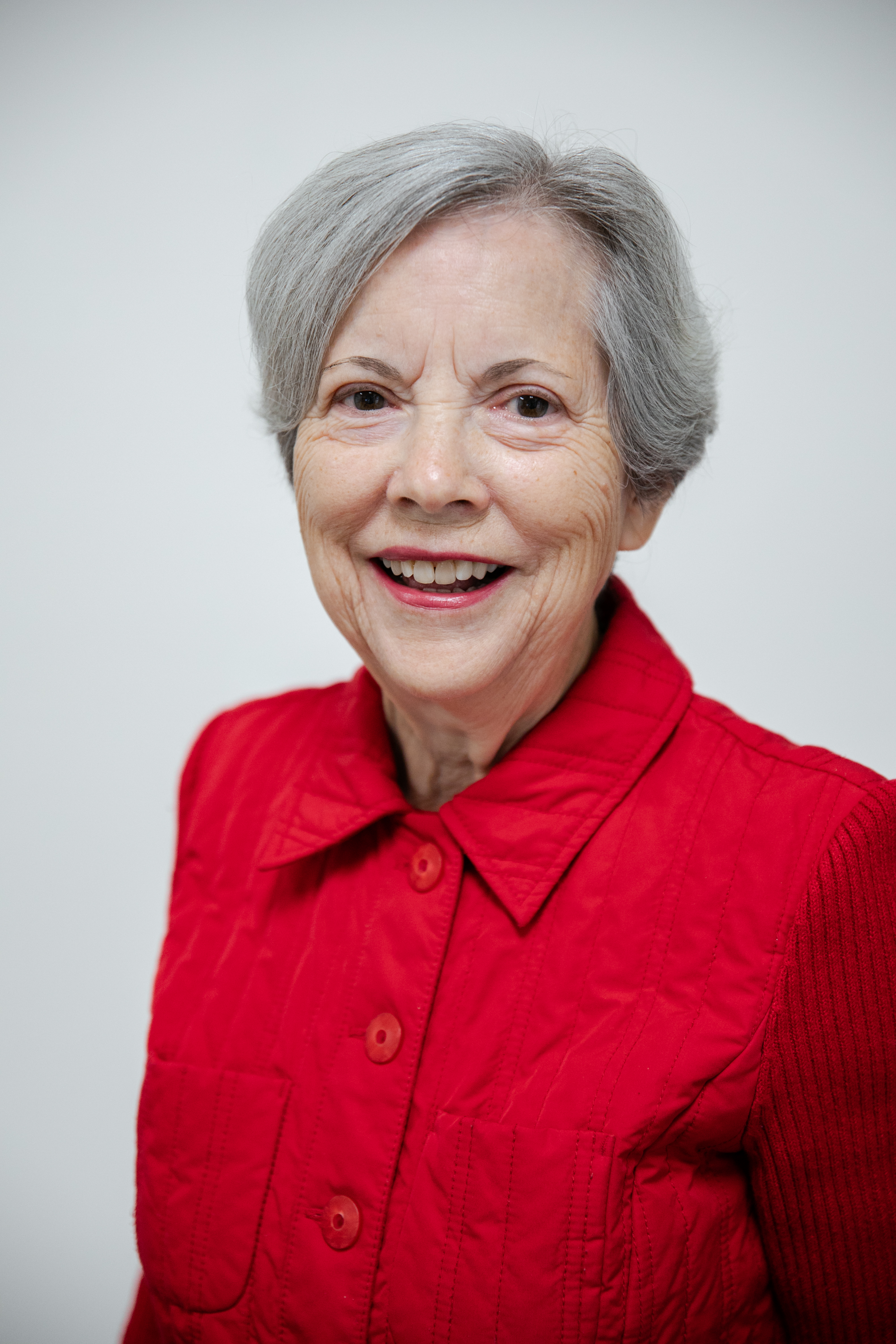 Diane Van Antwerp, office manager, in blue blazer, office manager at ZOVA chiropractic rehab center, showcasing a welcoming demeanor.